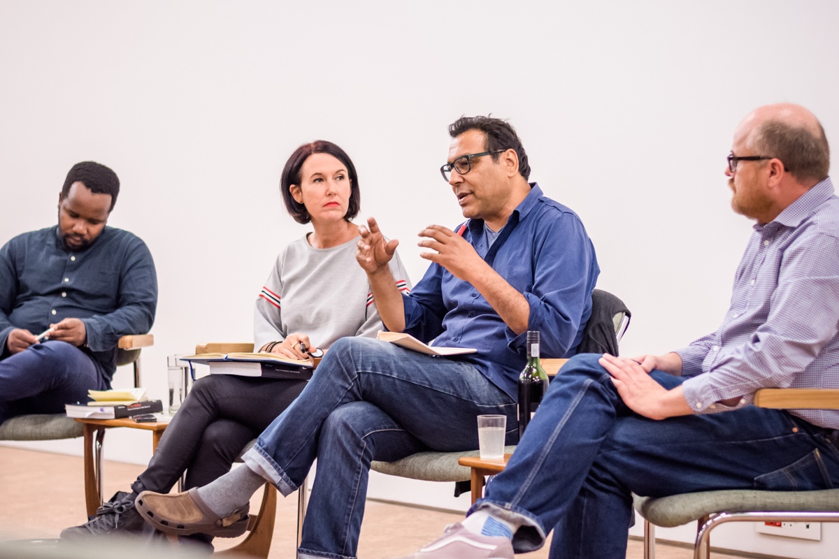 Event photograph from the book launch of Ashraf Jamal’s ‘In the World: essays on contemporary South African art’ on A4’s top floor that show the panellists seated on a row of chairs. From the left, Gcobani Sipoyo, Alexandra Dodd, Ashraf Jamal and Andrew Lamprecht.

