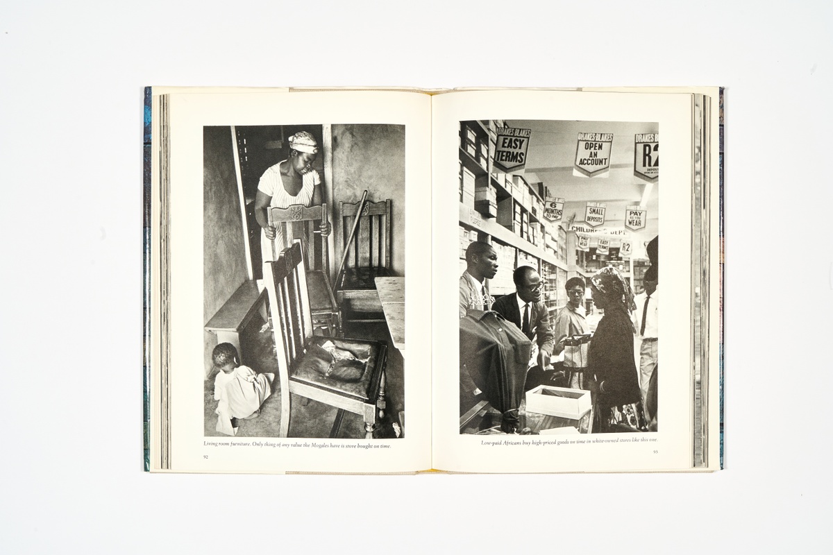 A topdown photograph of a 2-page spread from Ernest Cole's photo-book 'House of Bondage' on a white background.
