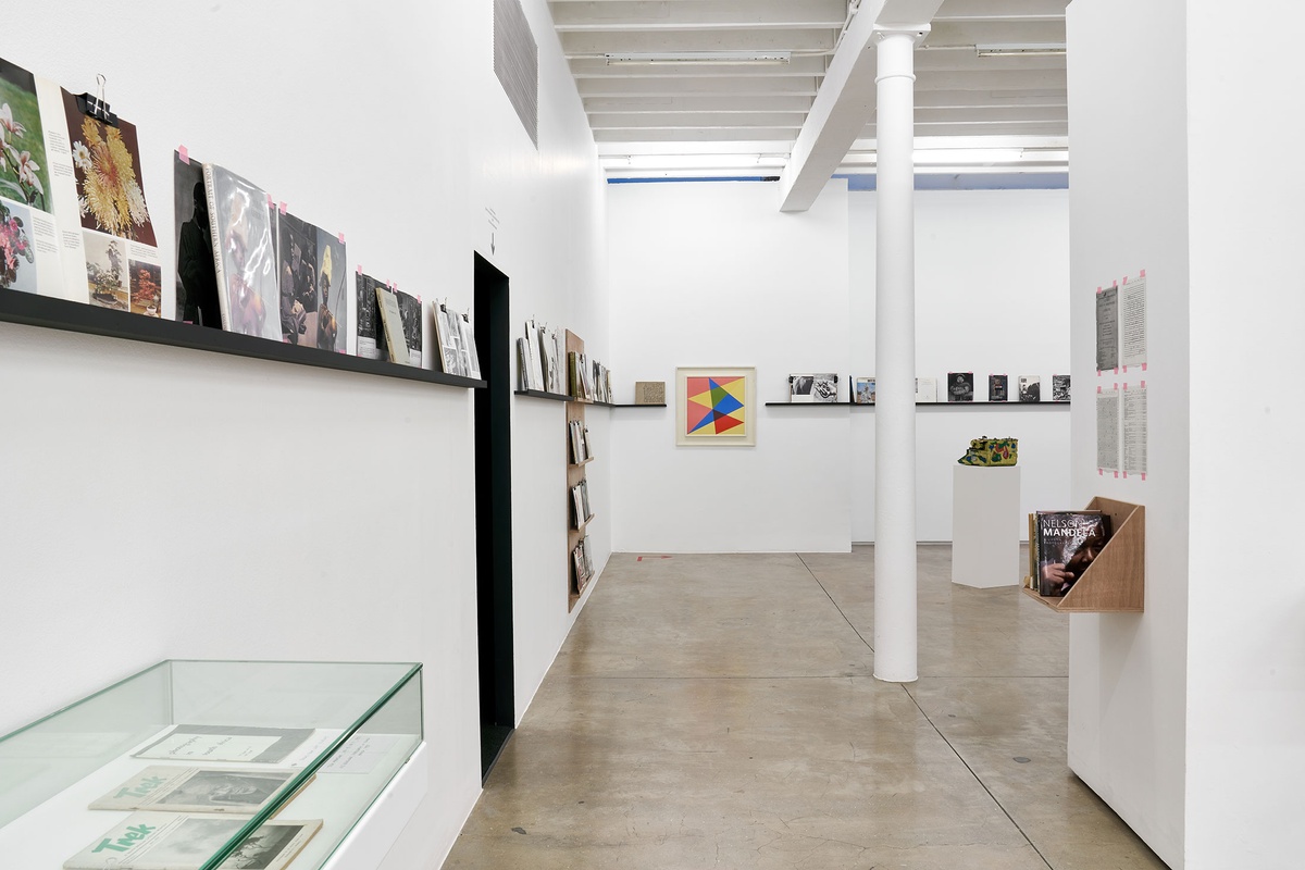 Installation photograph from the Photo Book! Photo-Book! Photobook! exhibition in A4’s Gallery. In the middle, Albert Newall’s oil painting ‘Harmonic Development within a Square’ hangs in an area dedicated to photobooks from the years 1945 to 1967.
