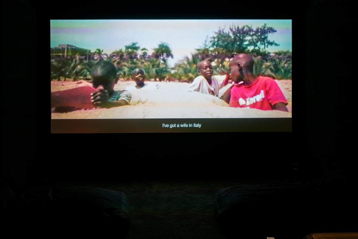 Installation photograph from the Customs exhibition in A4’s Gallery. At the back, Binelde Hycran’s video work ‘Cambeck’ is projected onto the wall of the darkened video room.
