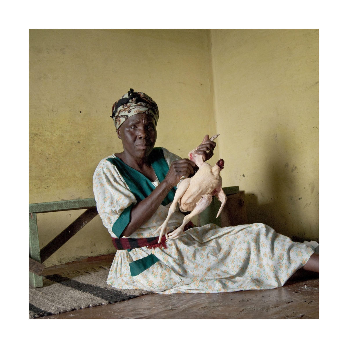 Photograph from Jabulani Dhlamini’s residency on A4’s top floor depicts an individual seated on the floor defeathering a bird.
