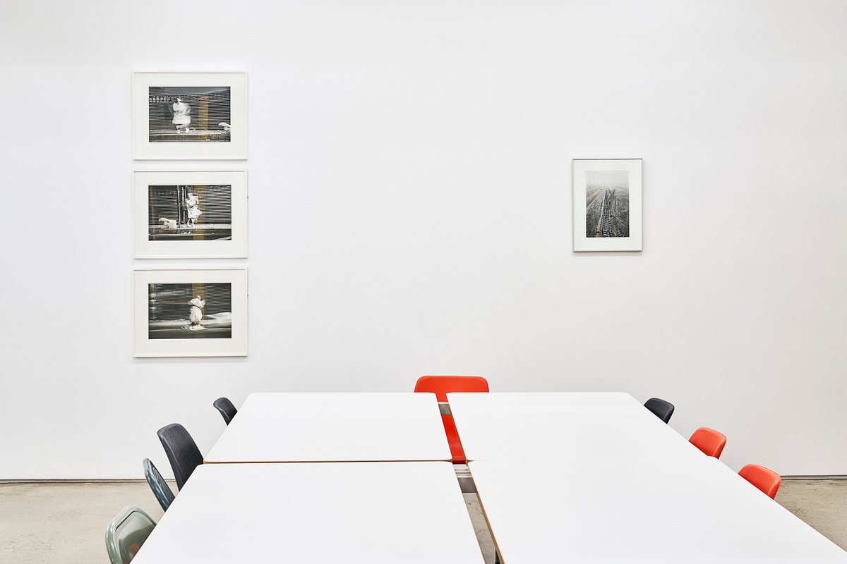 Installation photograph from the ‘Nowhere - No we're - Now here’ exhibition on A4’s ground floor. On the left, Sabelo Mlangeni’s photographic series ‘Invisible Woman’ is mounted on the wall. On the right, Santu Mofokeng’s photograph ‘End of the Line, KZ2-Auschwitz (Landscapes of Trauma)’ is mounted on the gallery wall.
