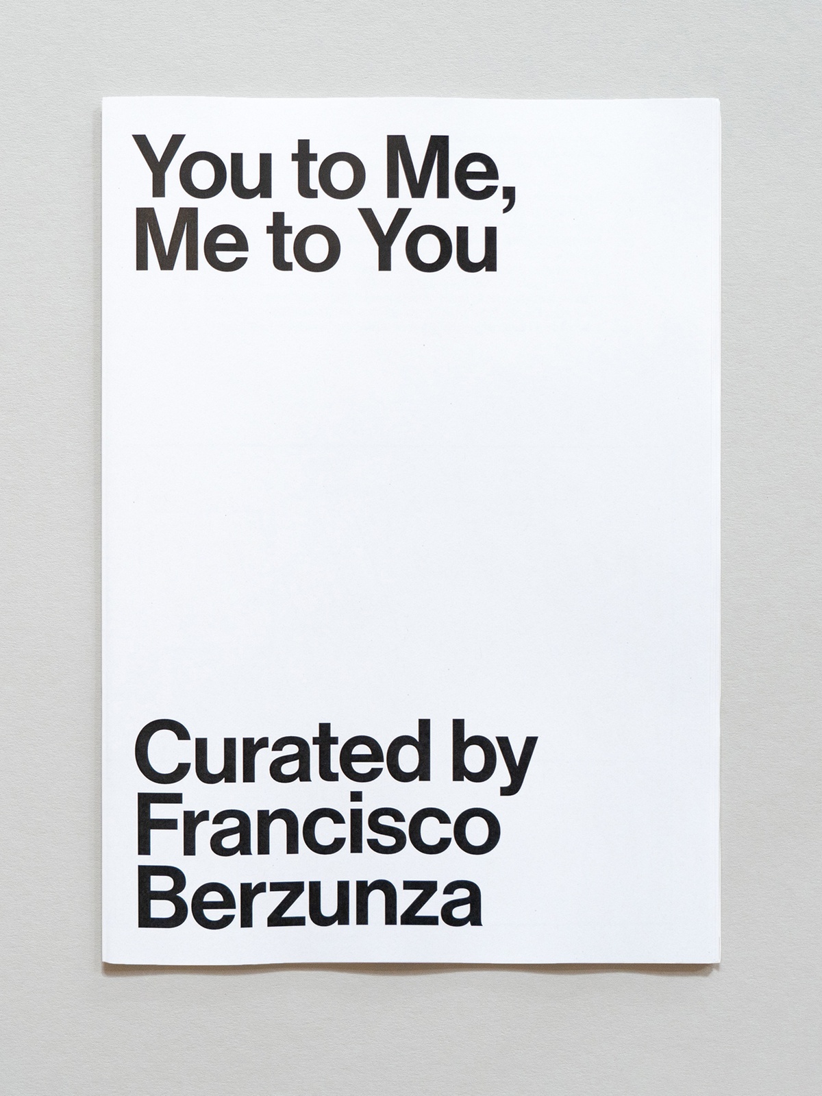 Photograph of the wayfinder publication for You to Me, Me to You curated by Francisco Berzunza in A4 Arts Foundation's Gallery.
