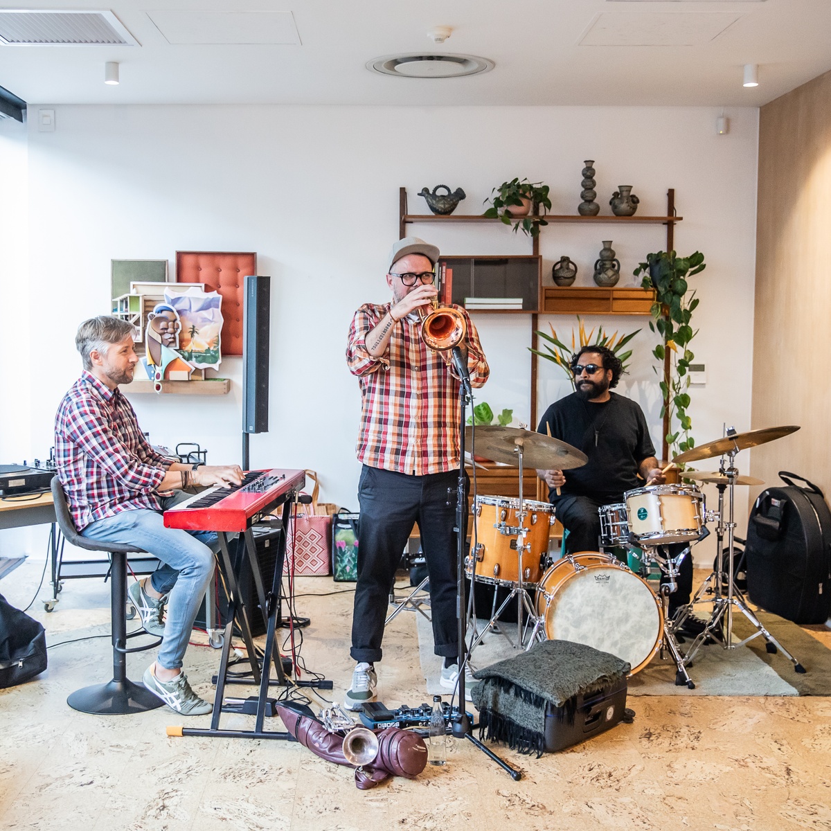 Event photograph from the preview of the 'A Little After This' exhibition in A4 Arts Foundation that shows The Regulars Jazz Trio performing on the top floor.
