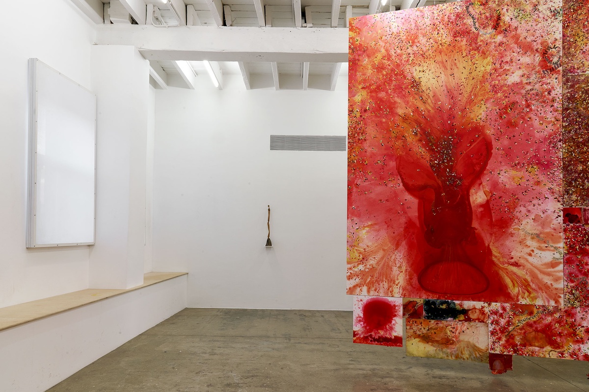 Installation photograph from the 'A Little After This' exhibition in A4 Arts Foundation's gallery. On the left, Lucas Sithole's carved yellowwood sculpture 'Not You!' sitting on a small wall-mounted shelf. On the right, an installation of Penny Siopis' glue, ink and oil 'Maitland' paintings suspended from the ceiling.
