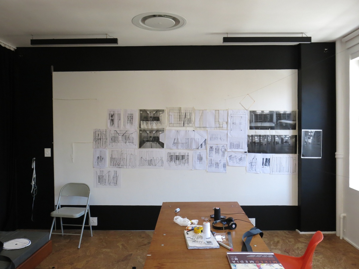 Process photograph from Unathi Mkonto’s residency on A4’s top floor that shows the wall of A4’s studio lined with drawings and photographs.
