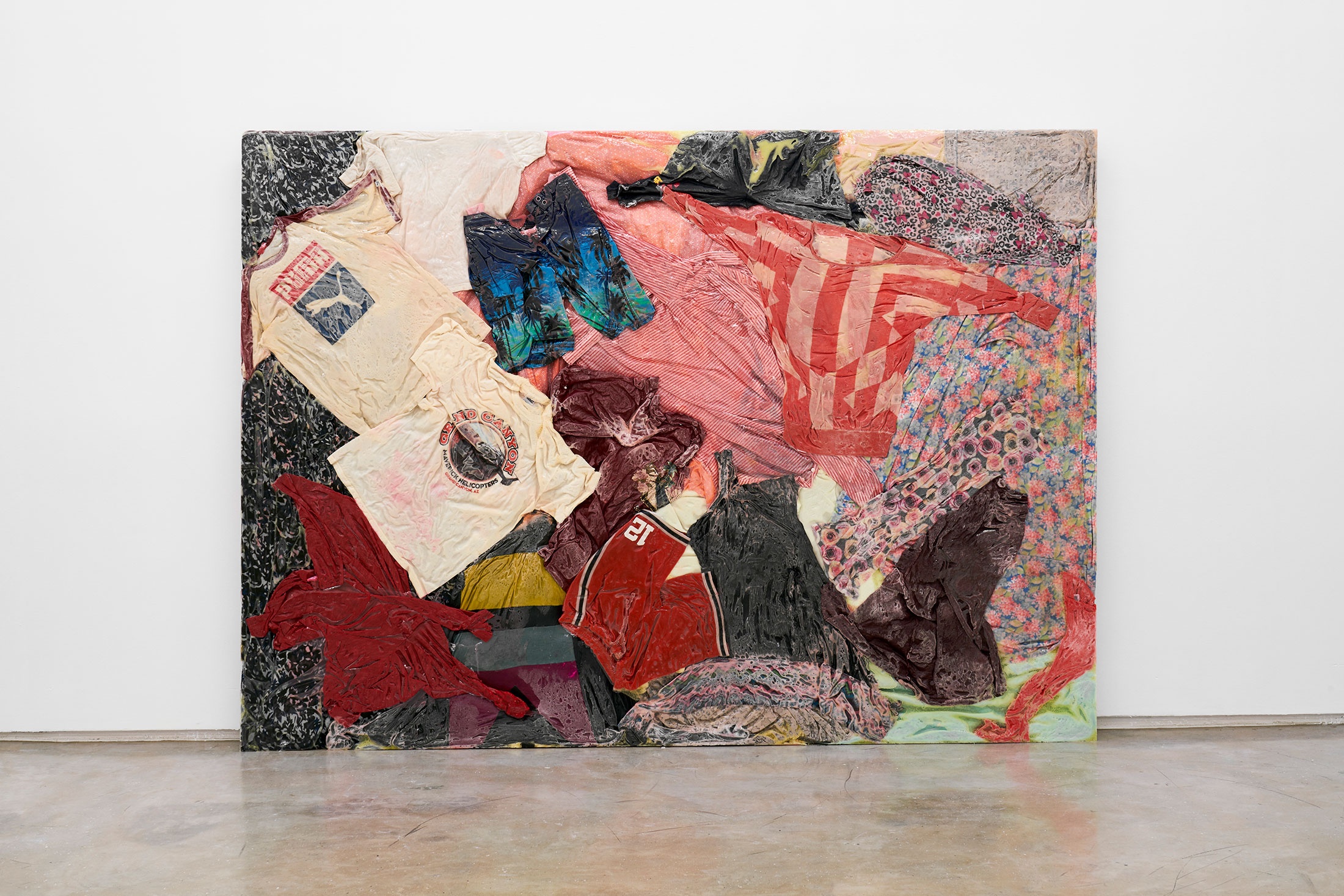 A photograph of Kevin Beasley's mixed media work 'Arizona South Africa' leaning against a white wall.
