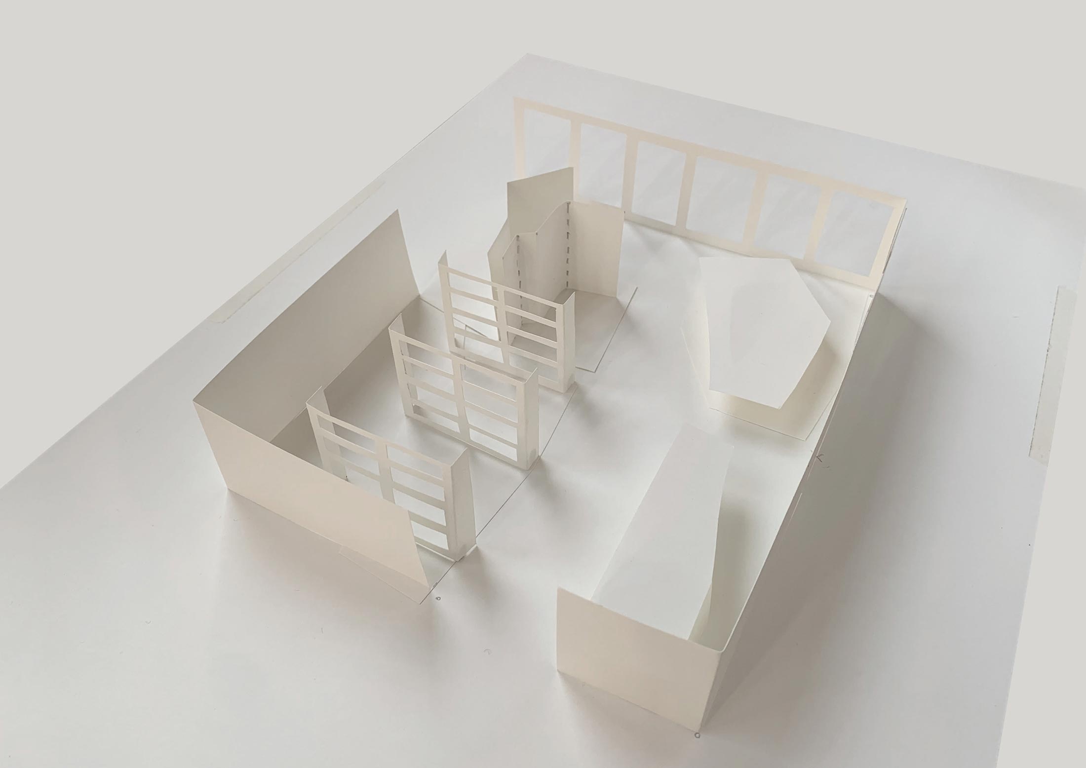 Process photograph from ‘Landscaping the Store,’ Meghan Ho-Tong’s redesign of A4’s Proto~ museum store. A cardboard maquette of A4’s foyer shows three rows of bookshelves and a display cabinet on the left, and a reception counter and seating area on right.
