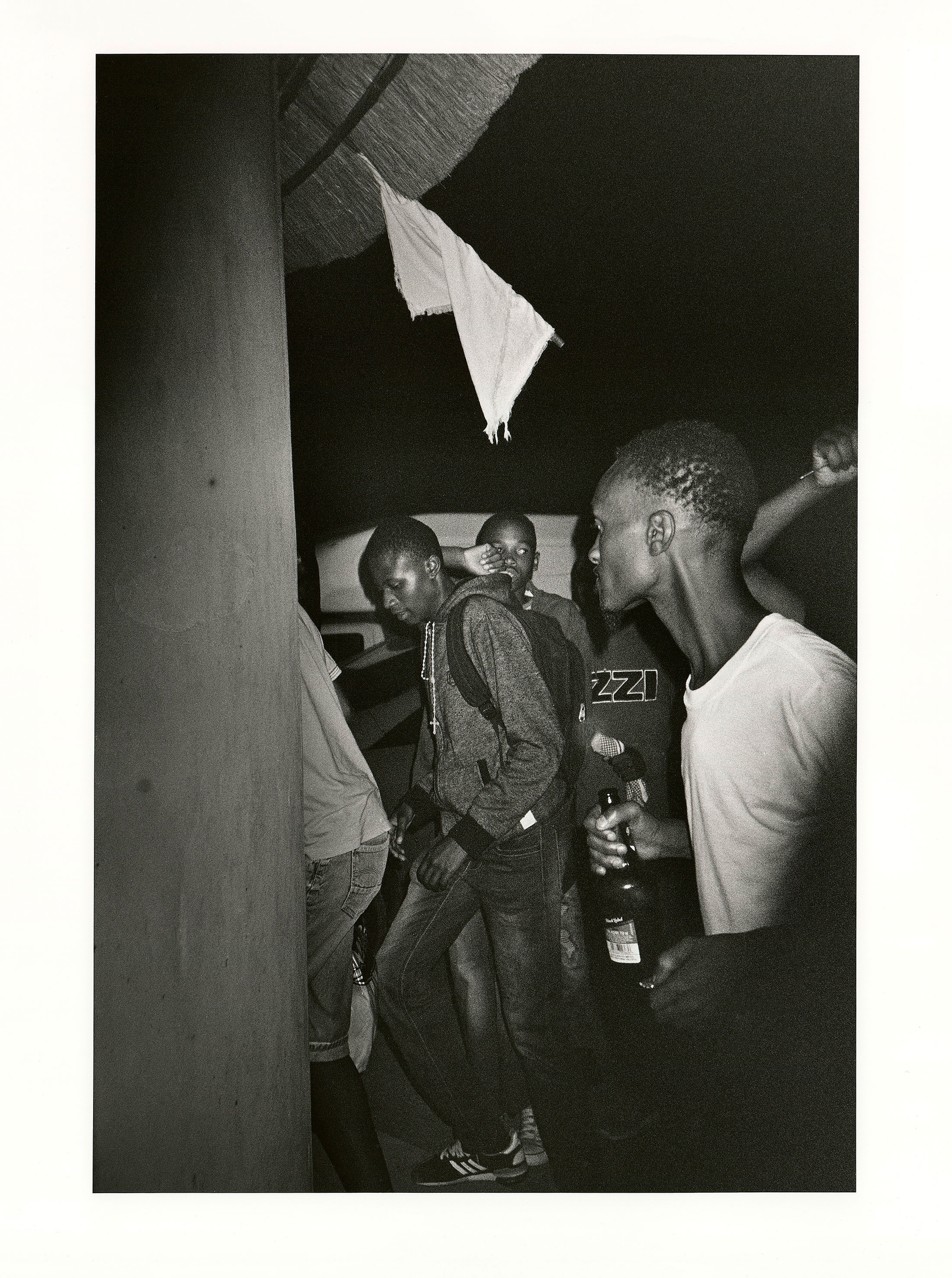 Sabelo Mlangeni’s ‘Emfundelweni, Ukavala unyawo’, a black and white photograph depicting people attending a wedding.
