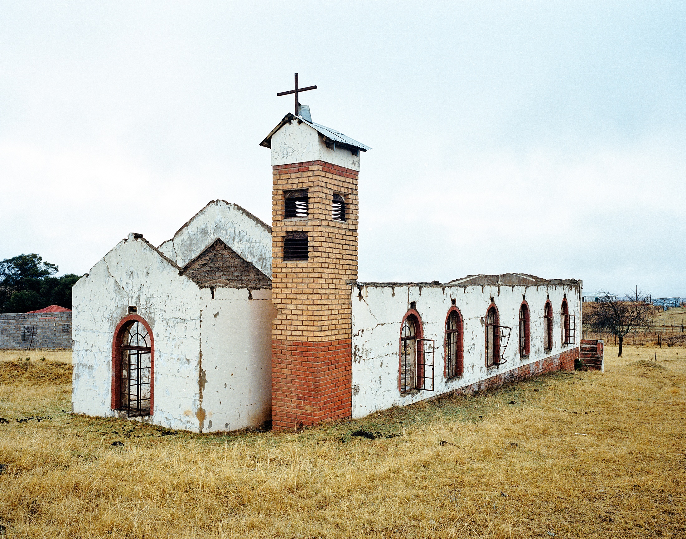 Lindokuhle Sobekwa's photograph 'eDonkey Church' shows a dilapidated church surrounded by grass.
