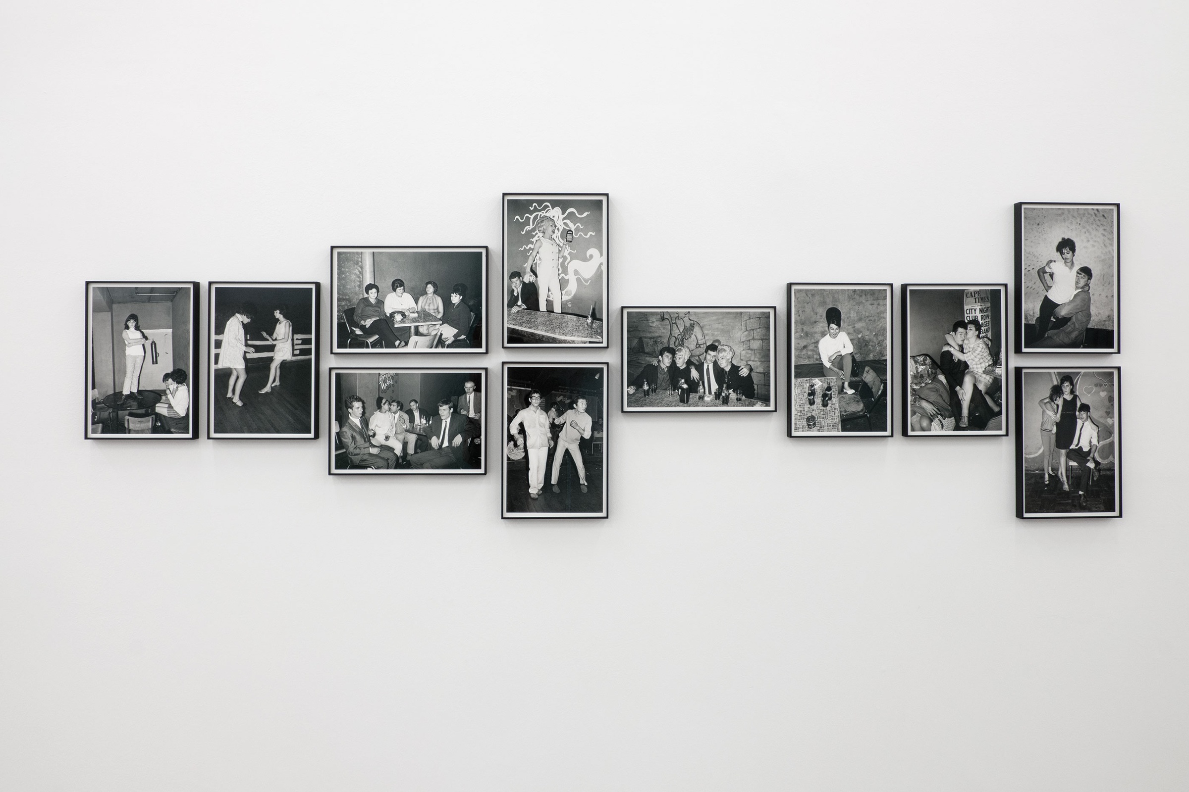 A photograph shows Billy Monk's monochrome photographic series 'The Catacombs 56' mounted on a white wall.
