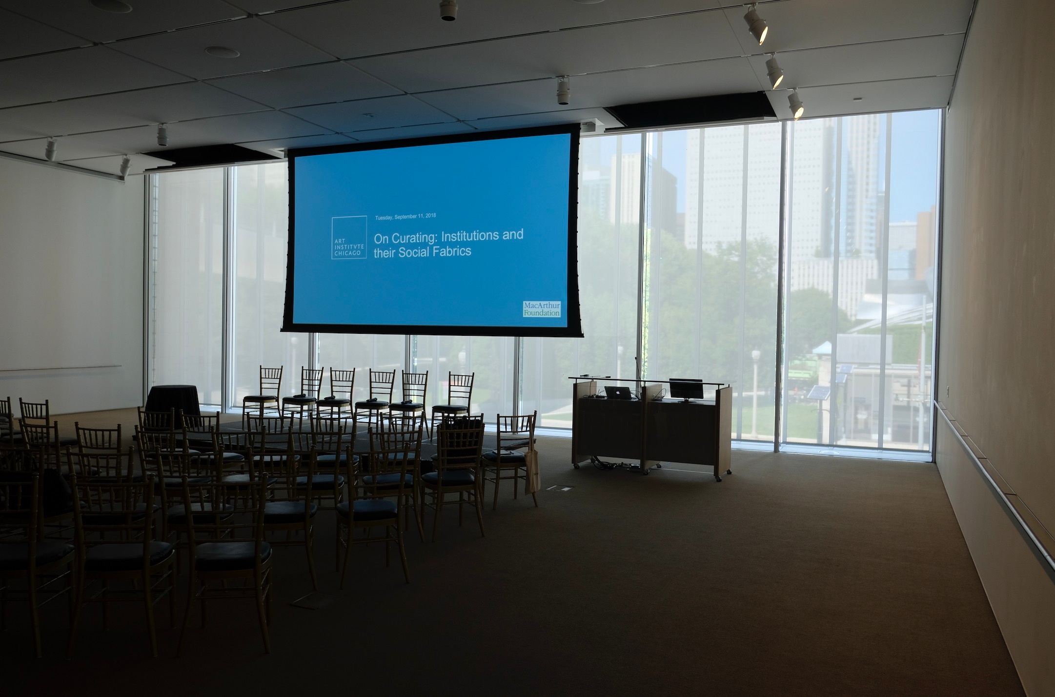 Event photograph from the offsite event ‘On Curating: Institutions and their Social Fabrics’ at the Art Institute of Chicago that shows a boardroom set up with a projection screen and seating.
