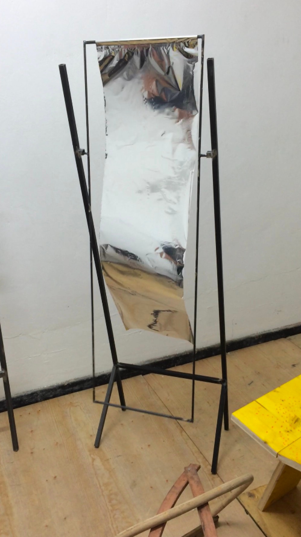 A photograph of Lyall Michael Sprong's mild steel, clamp and metalised foil sculpture 'Waving'.
