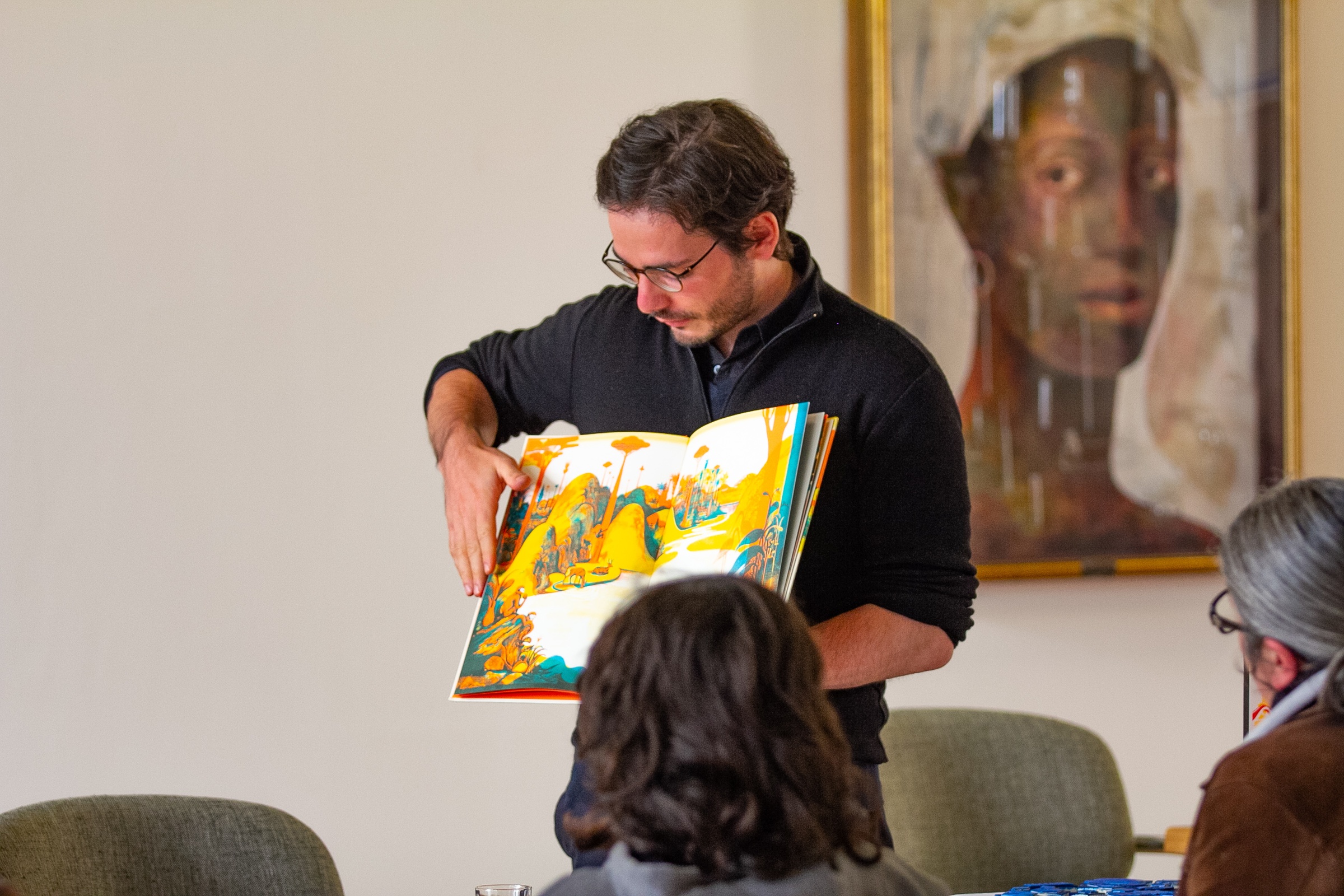 Event photograph from the 2018 rendition of the Open Book festival on A4’s ground floor that depicts the Cencertina Books Workshop on A4’s top floor. At the front, attendees are seated along a table. At the back, Raphael Urwiller from Icinori.
