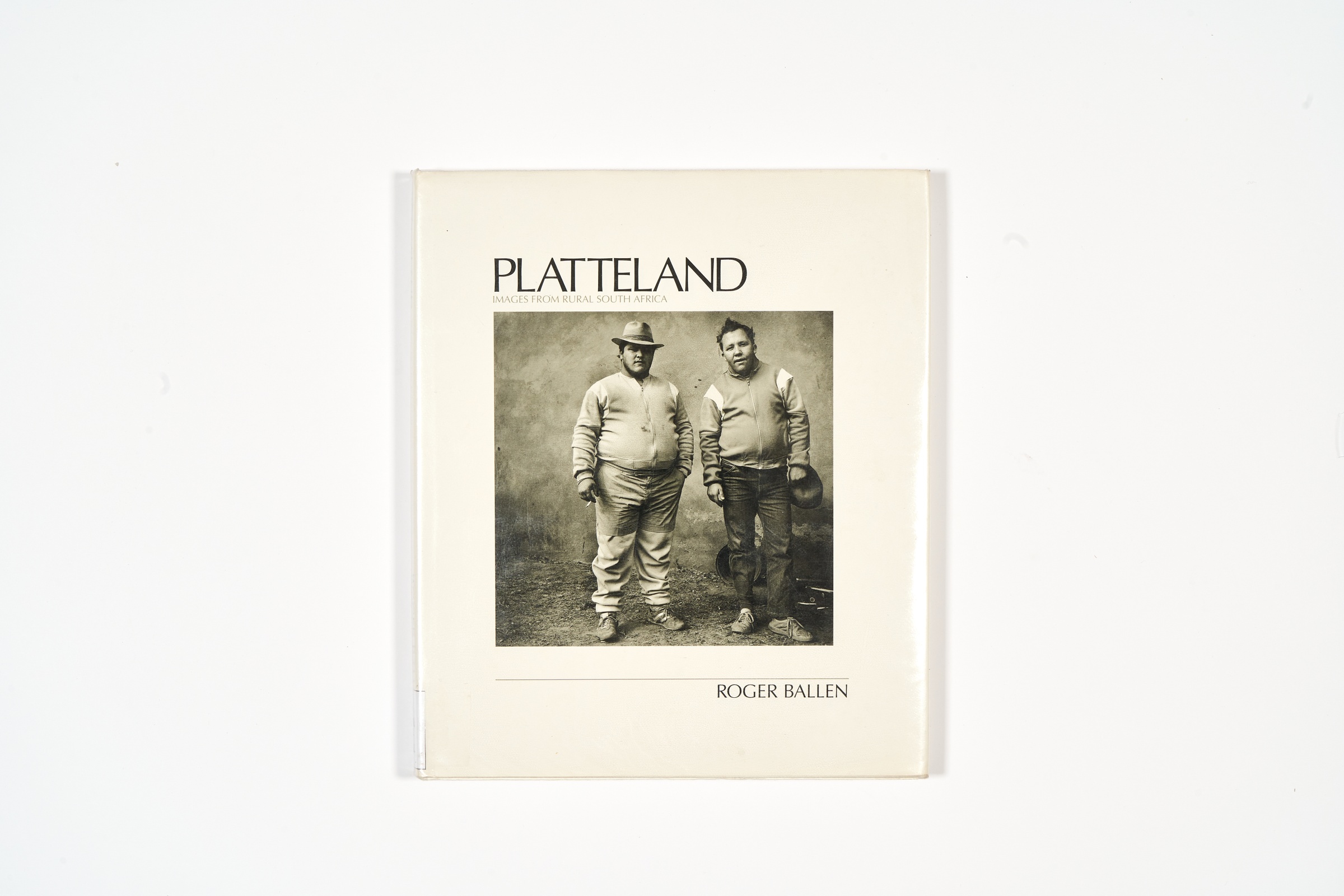 A topdown photograph of the cover of Roger Ballen's photo-book 'Platteland: Images from Rural South Africa' on a white background.
