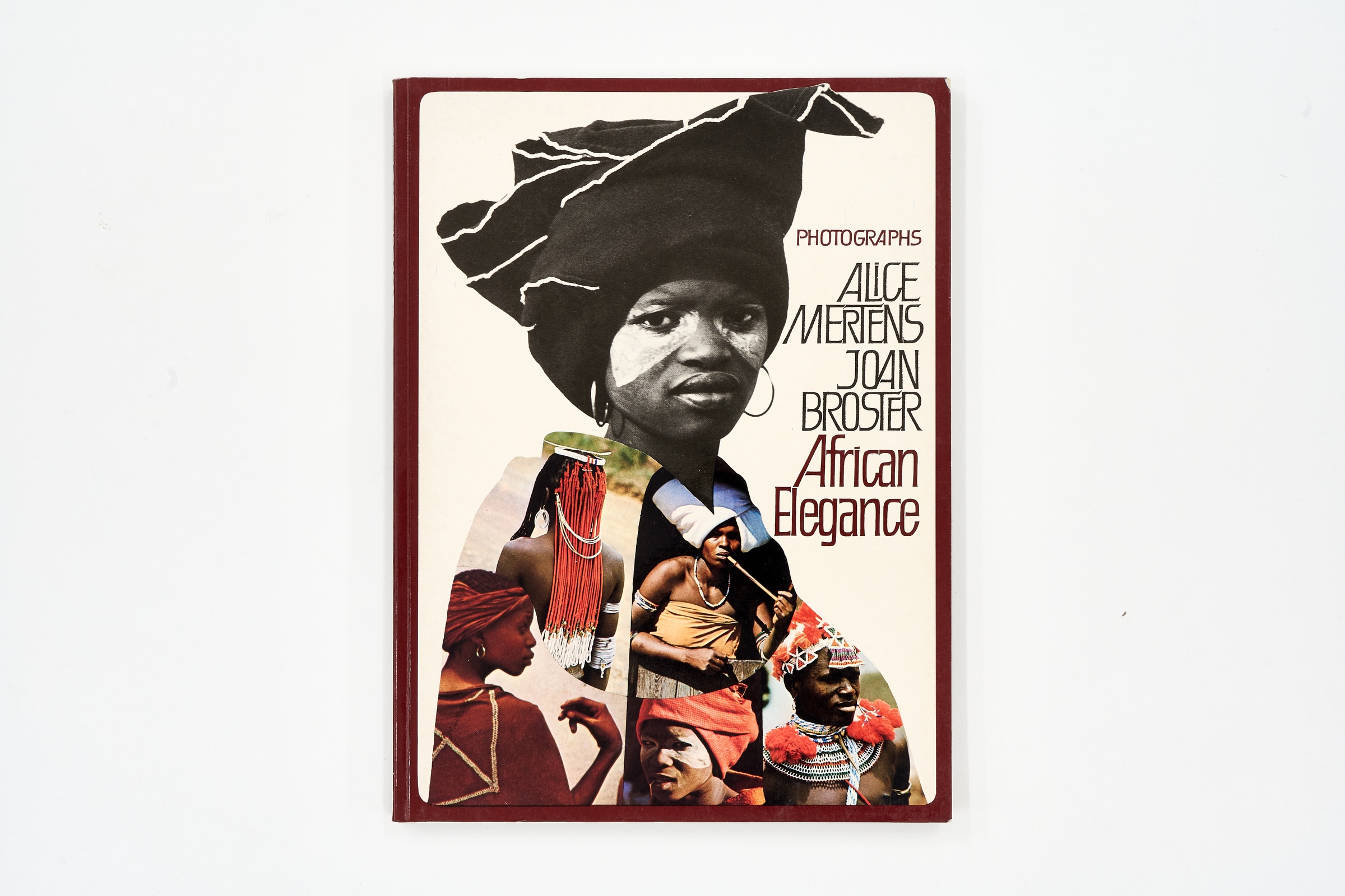 A topdown photograph of the cover of Alice Mertens' photo-book 'African Elegance' on a white background.
