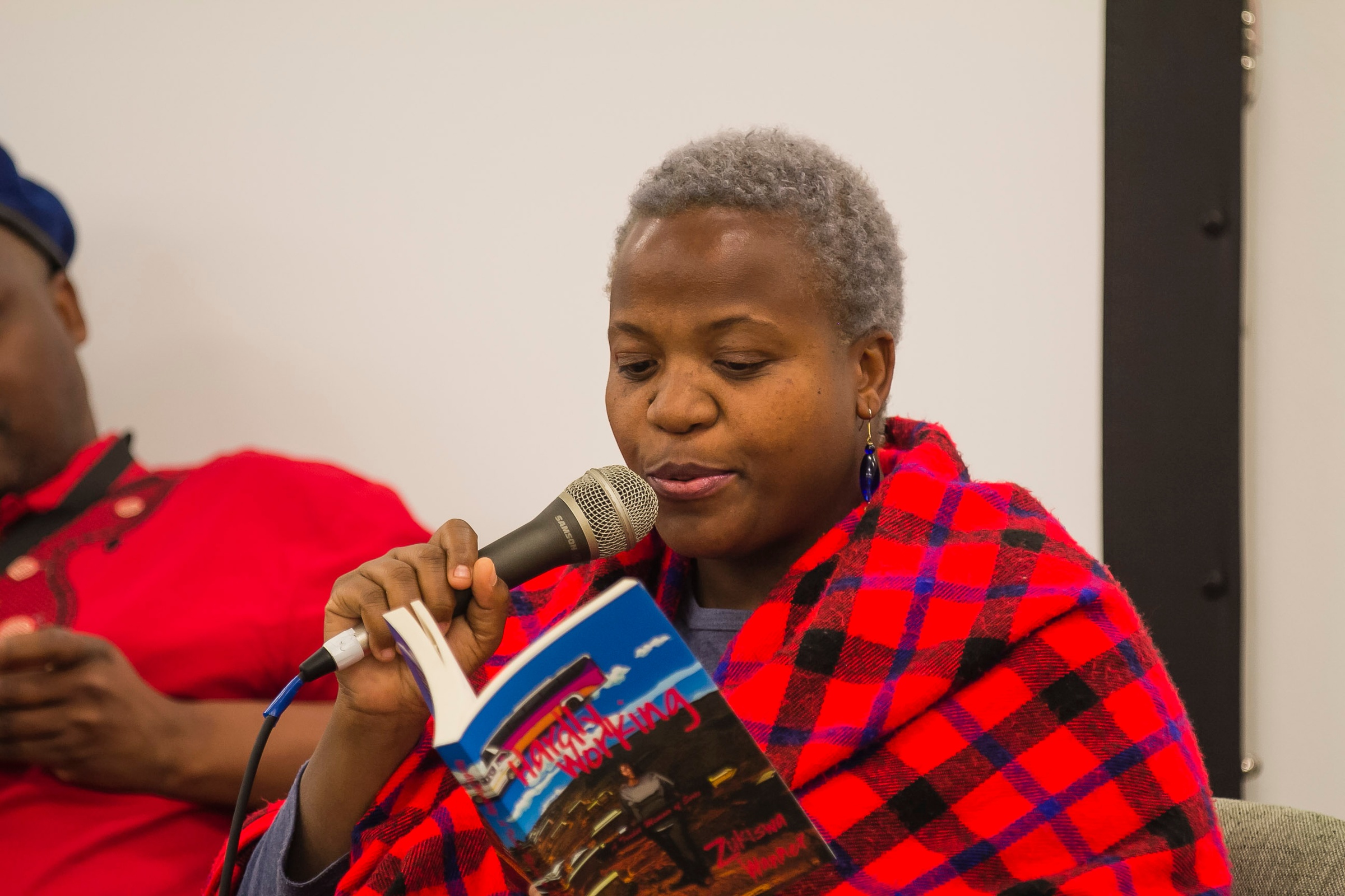 Event photograph from the 2018 rendition of the Open Book festival on A4’s ground floor. Zukiswa Wanner reads from her book 'Hardly Working'.
