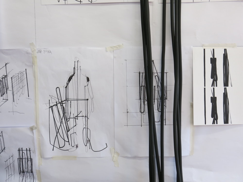 Process photograph from the ‘Wearables’ workshop with Unathi Mkonto on A4’s top floor. A white wall hosts drawings on paper and strips of velcro.
