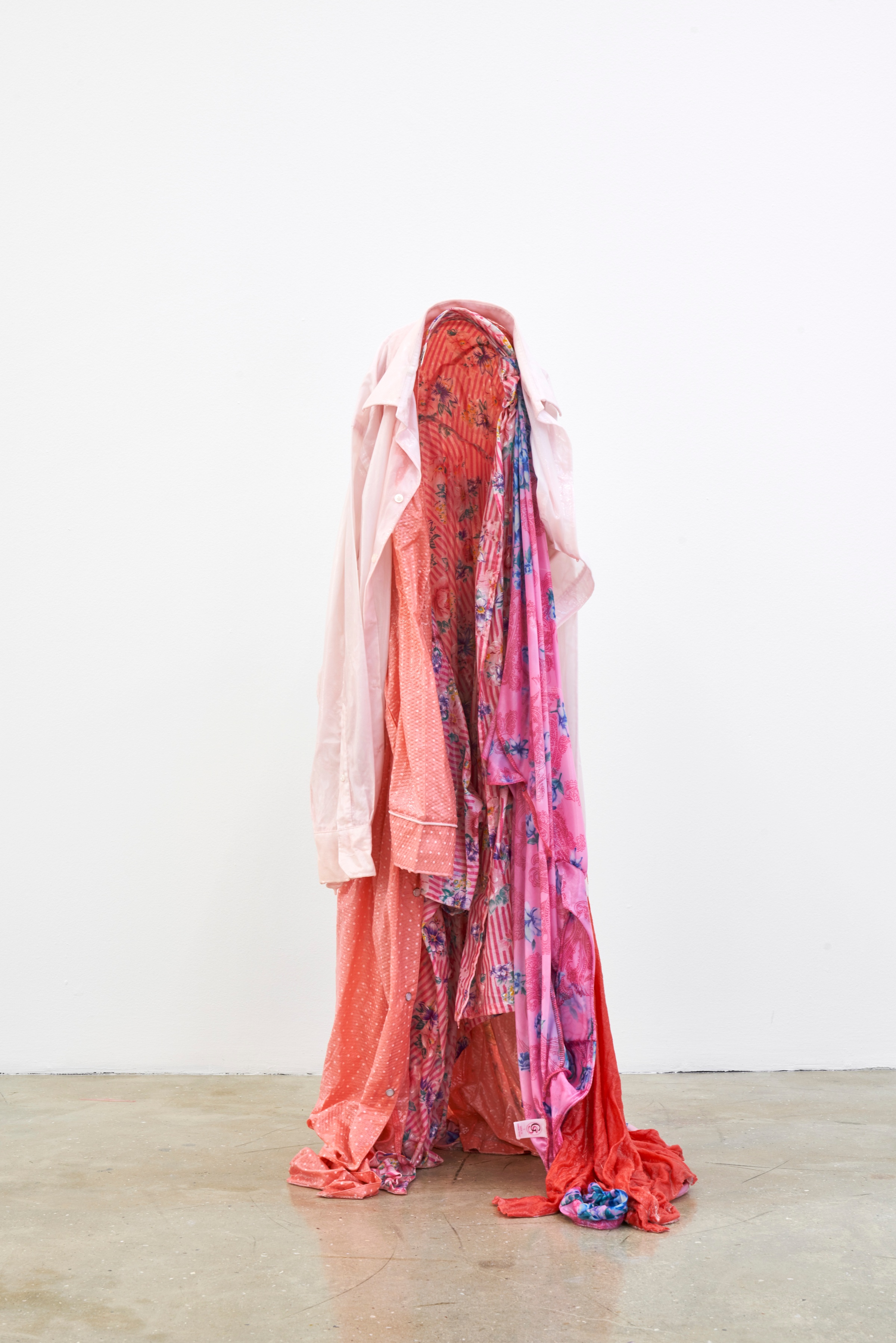 A photograph of Kevin Beasley's untitled garment and resin sculpture standing on a gallery floor.
