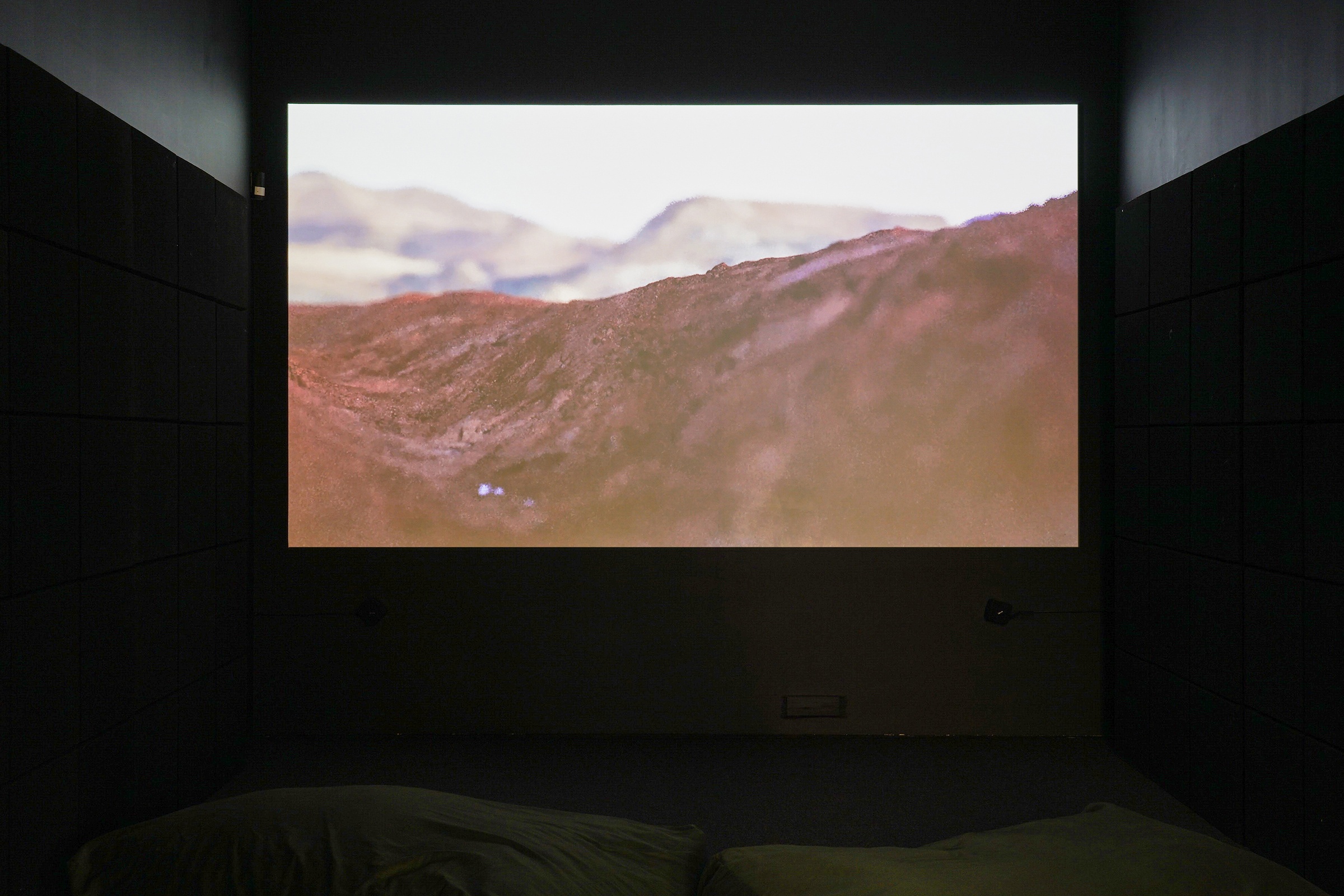 Installation photograph from the ‘Sounding the Void, Imaging the Orchestra V.1’ exhibition in A4’s Gallery. At the back, Jenna Sutela’s video ‘nimiia cétiï’ is projected onto the wall of the gallery viewing room.
