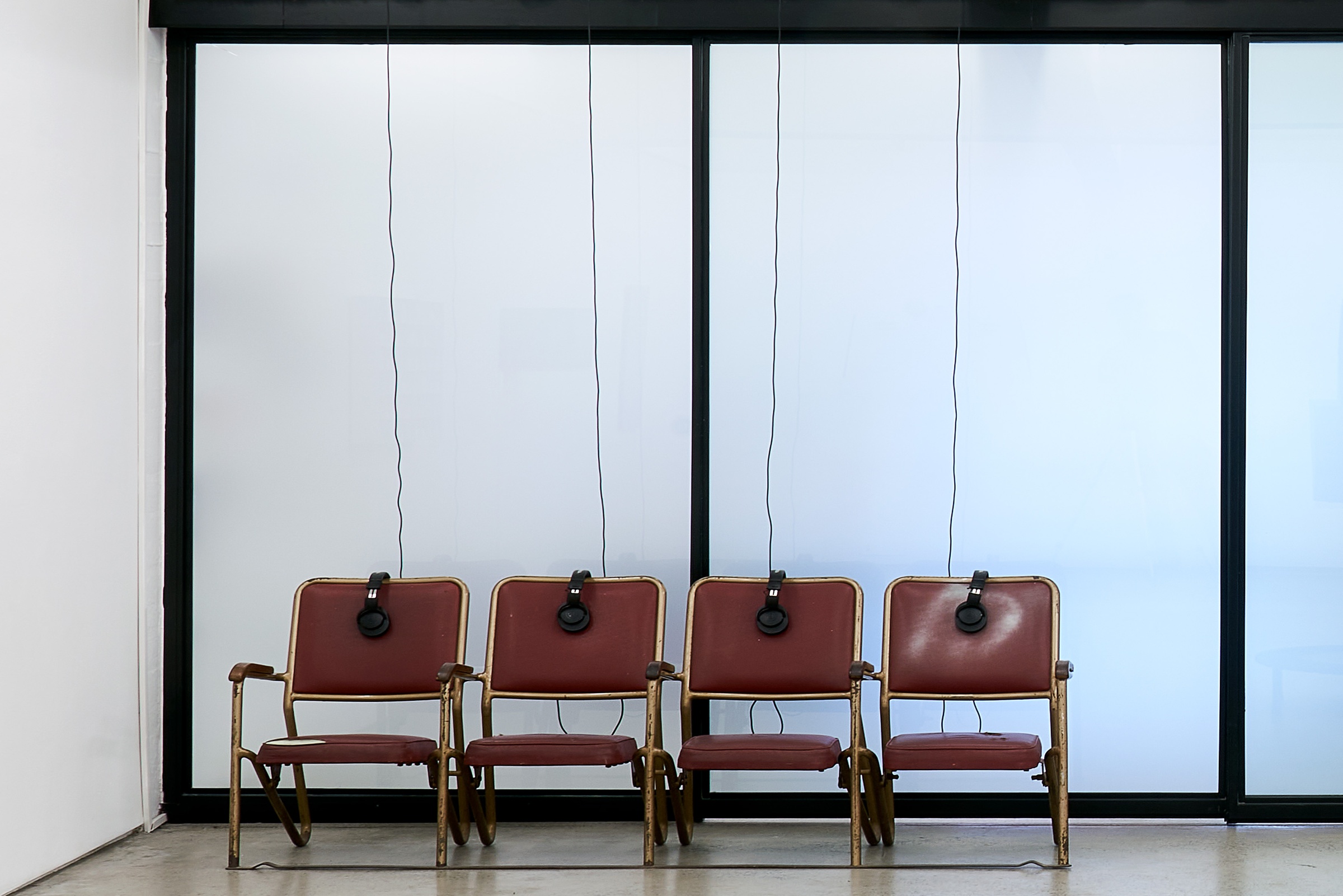 Installation photograph from the ‘Model’ exhibition in A4’s Reading Room. Bhavisha Panchia sound installation 'Imagine you're in a museum: What do you hear?' consists of four chairs with headphones.
