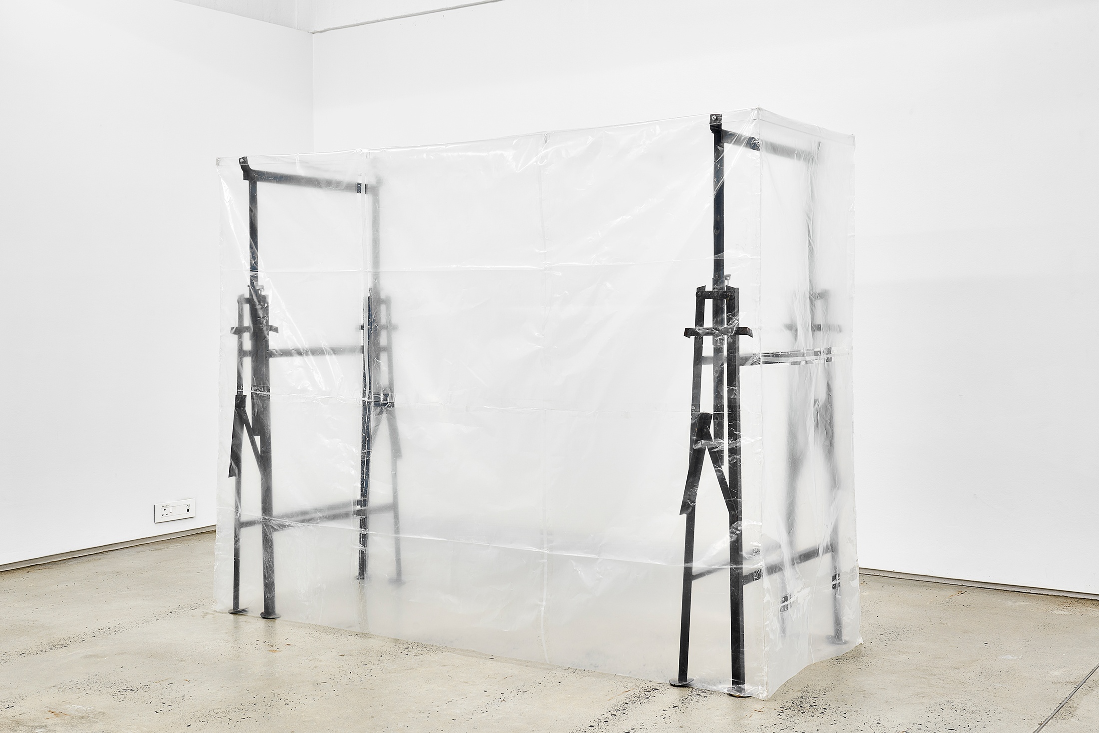 An installation photograph shows Gian Maria Tosatti's mixed media installation 'Void #2' sitting on a concrete floor.

