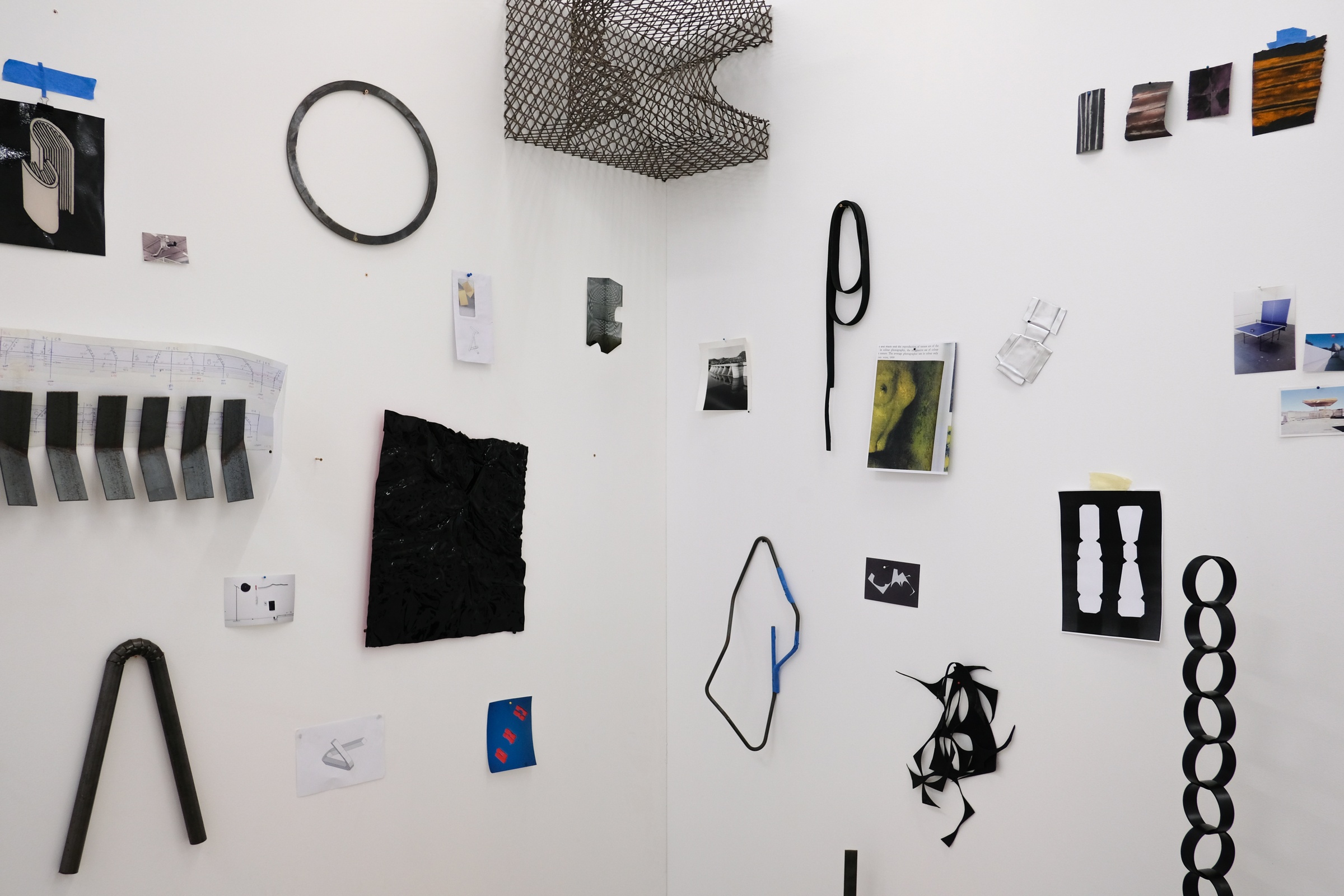 Installation photograph from the 2018 rendition of ‘Parallel Play’ in A4’s Gallery. Various sculptural objects and ephemera from Kyle Morland’s practice are arranged on the walls in a corner of the gallery.
