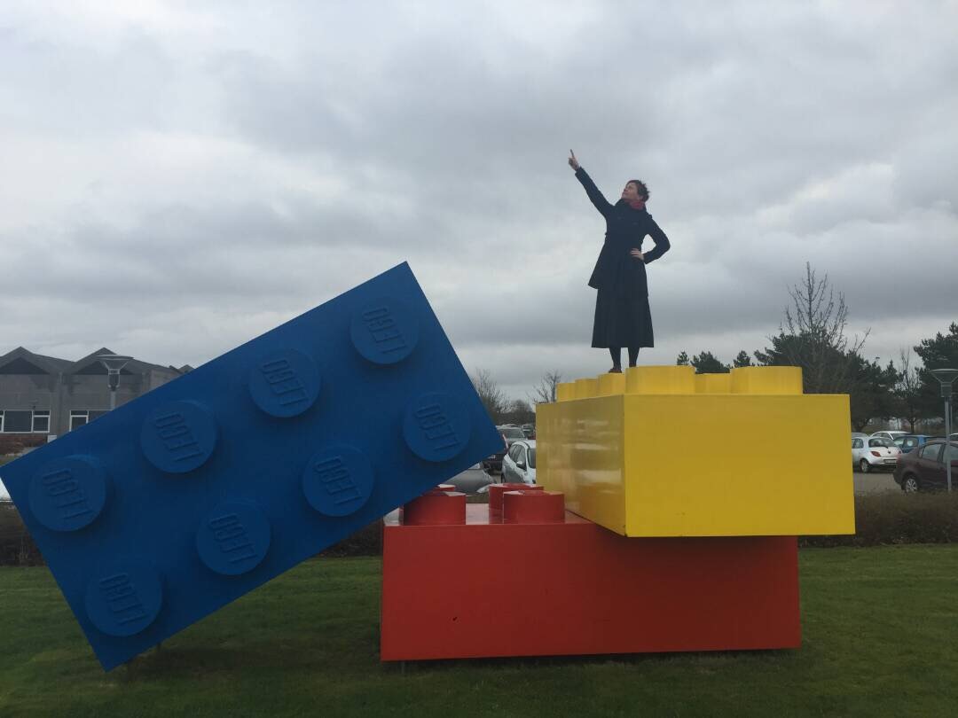 Ephemera from Anthea Moys’ residency on A4’s top floor. A photograph depicts an individual standing on giant lego pieces in a park.
