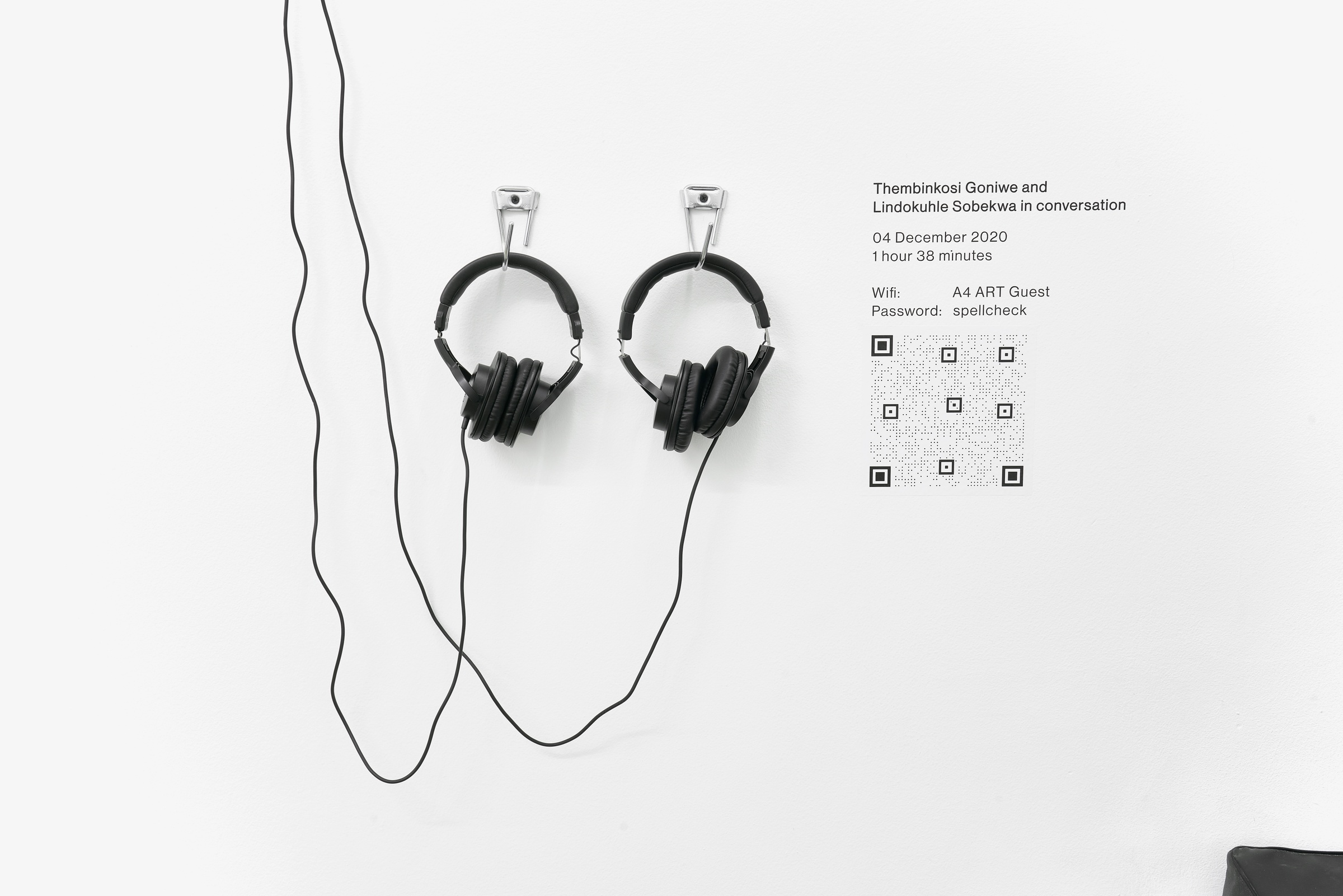 A listening station hosts an audio recording of a conversation between Lindokuhle Sobekwa and Thembinkosi Goniwe, with two pairs of headphones.
