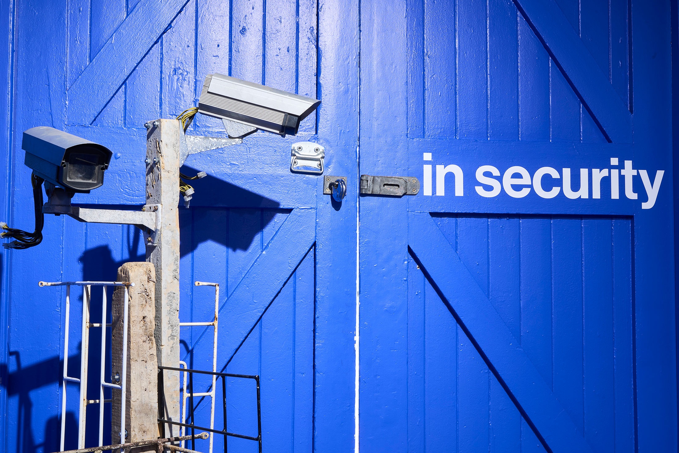 Installation photograph from the ‘In Security’ exhibition in A4’s Goods project space, with Gaelen Pinnock’s sculptural assemblages made up of security cameras, burglar bars and concrete slabs.
