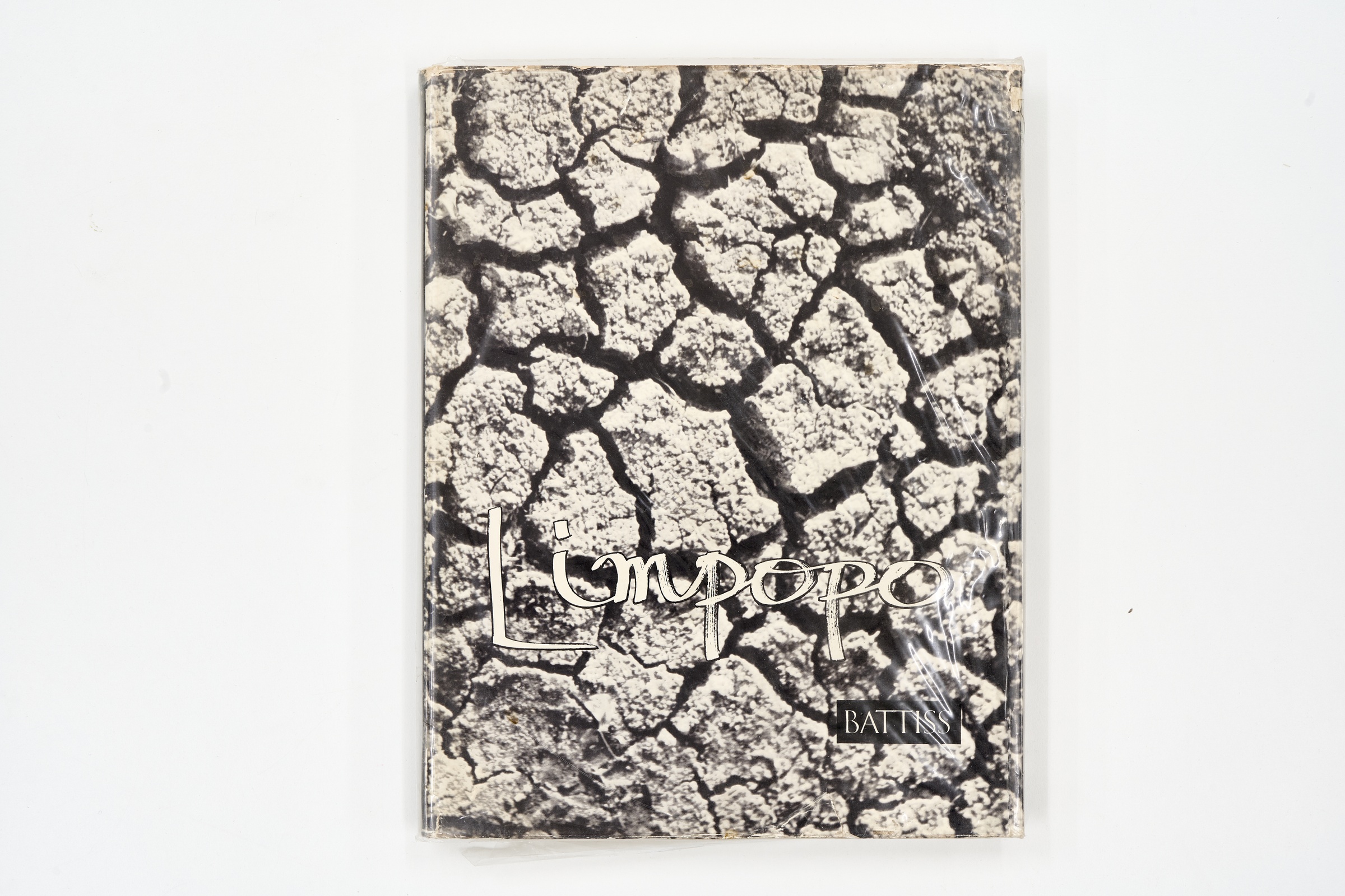A topdown photograph of the cover of Walter Battiss' photo-book 'Limpopo' on a white background.
