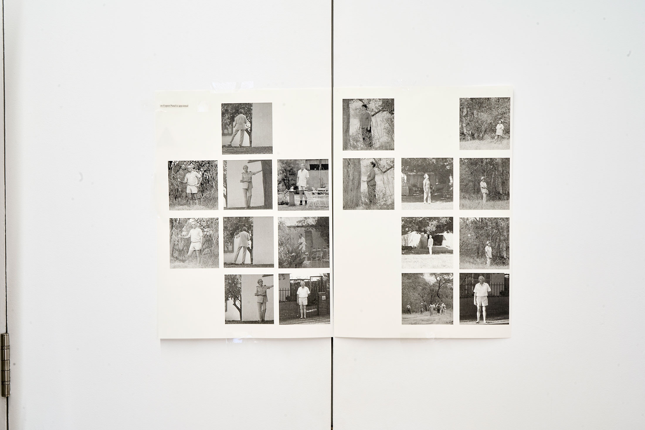 Installation photograph of Michael Tymbios’ studio during his residency in A4 Arts Foundation. A grid of photographic prints on two sheets are mounted on the doors of a white cupboard.
