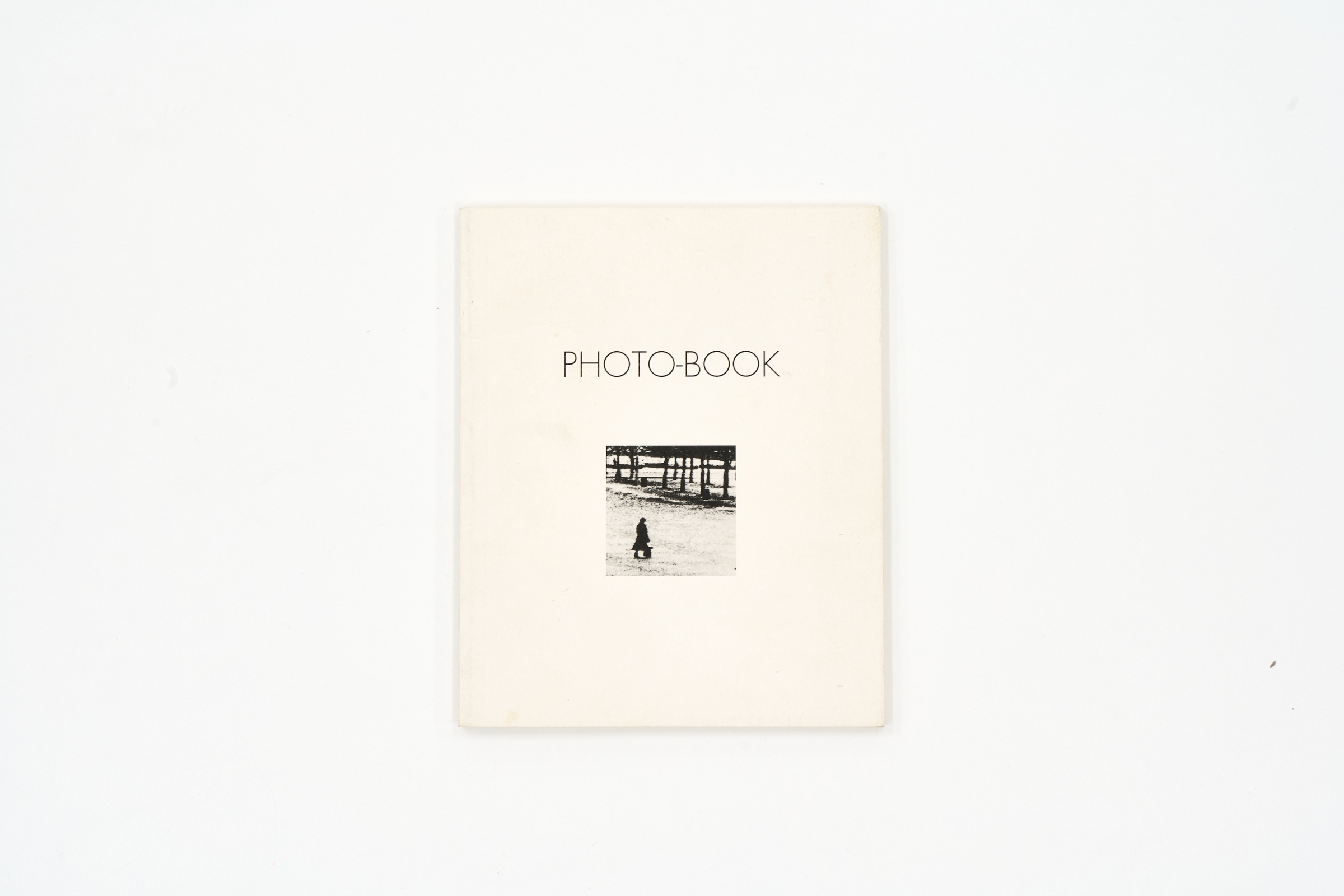 A topdown photograph of the cover of Jane Alexander's photo-book 'PHOTO-BOOK: Photomontages by Jane Alexander' on a white background.
