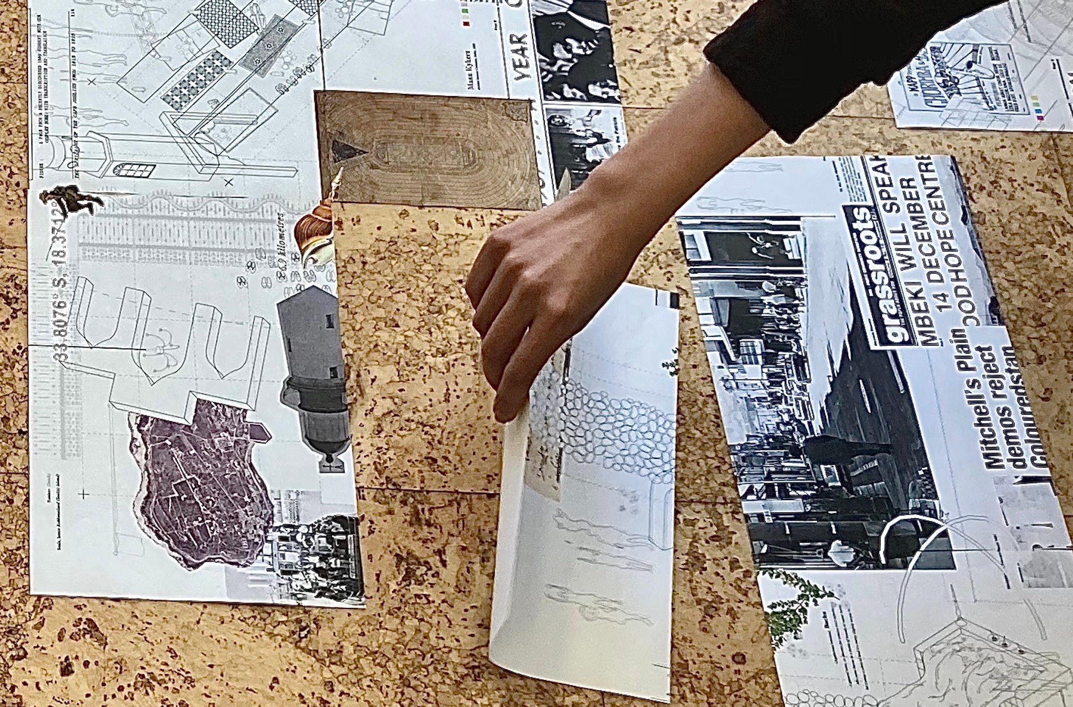 Process photograph from Sumayya Vally’s residency at A4. Sumayya arranges photocopies of archival material on a cork floor.
