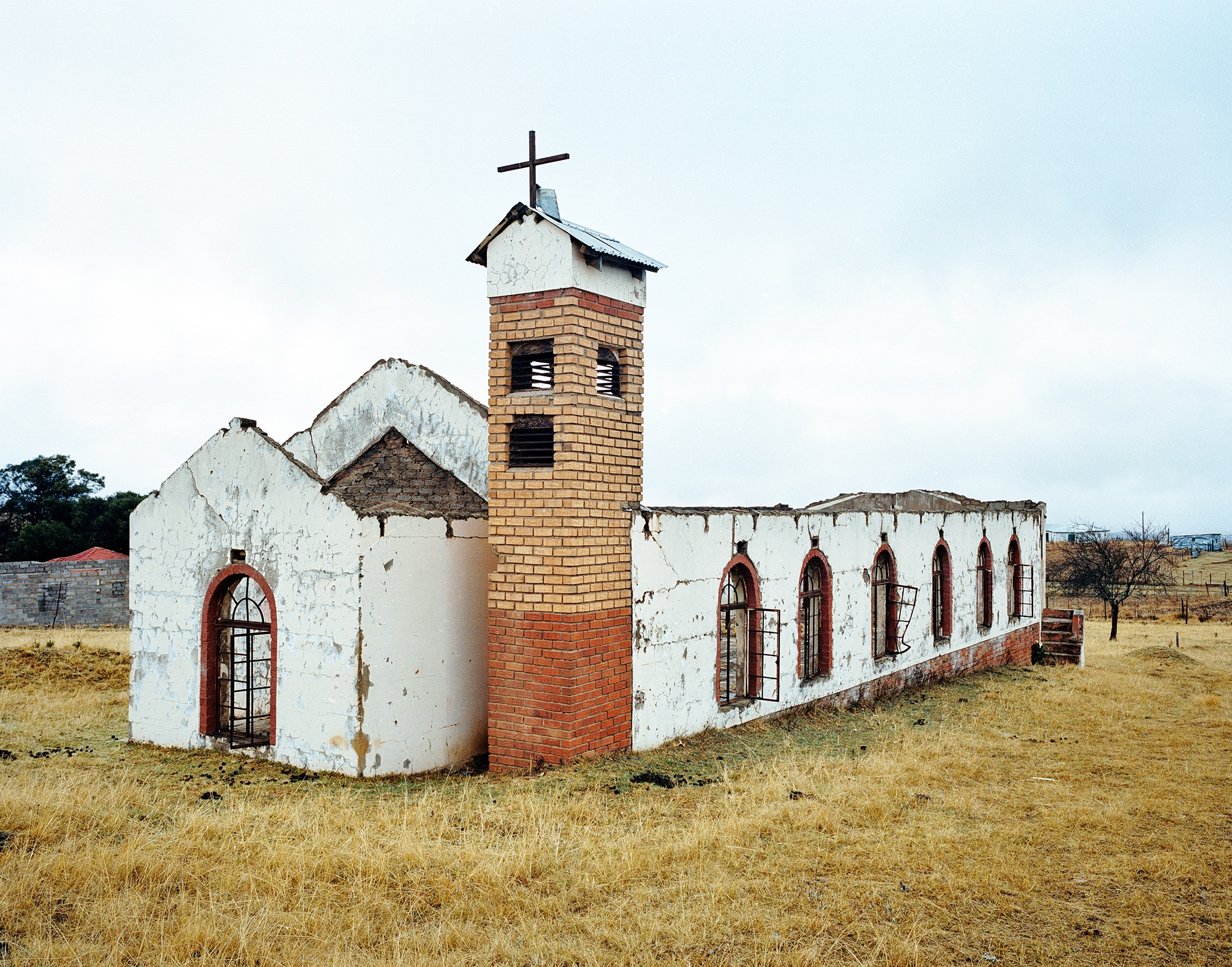 Lindokuhle Sobekwa's photograph 'eDonkey Church' shows a dilapidated church surrounded by grass.
