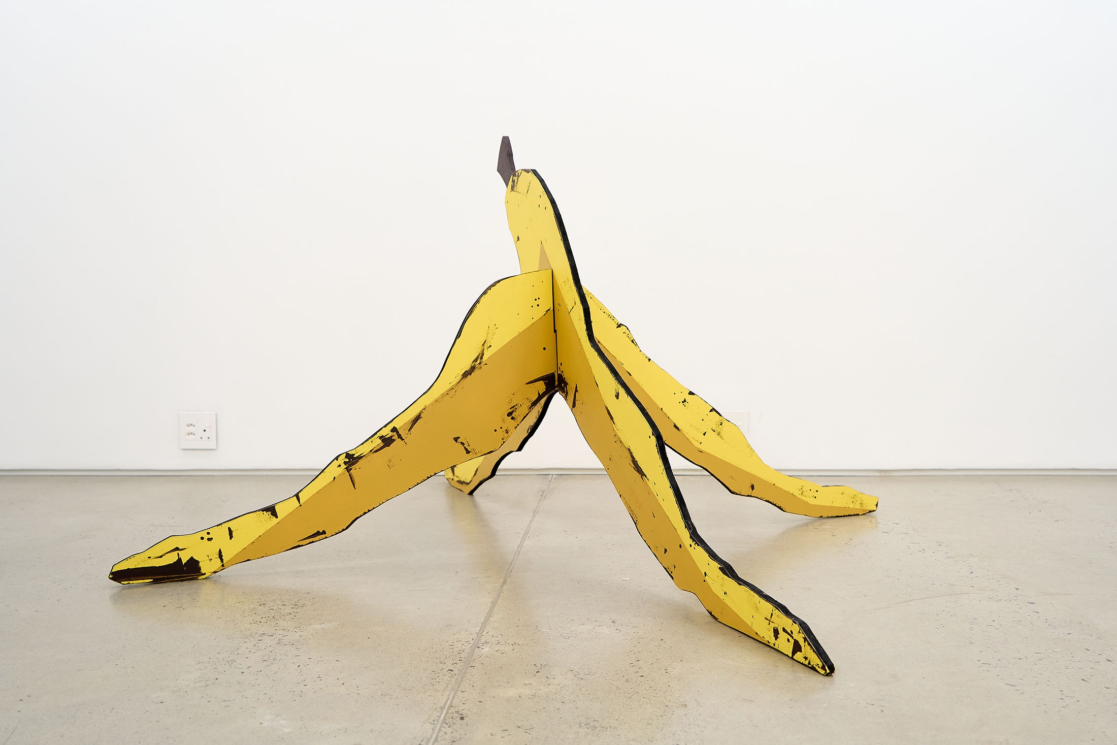 Installation photograph of Guy Simpson's painted MDF board sculpture 'Banana' in A4 Arts Foundation's Proto museum store.
