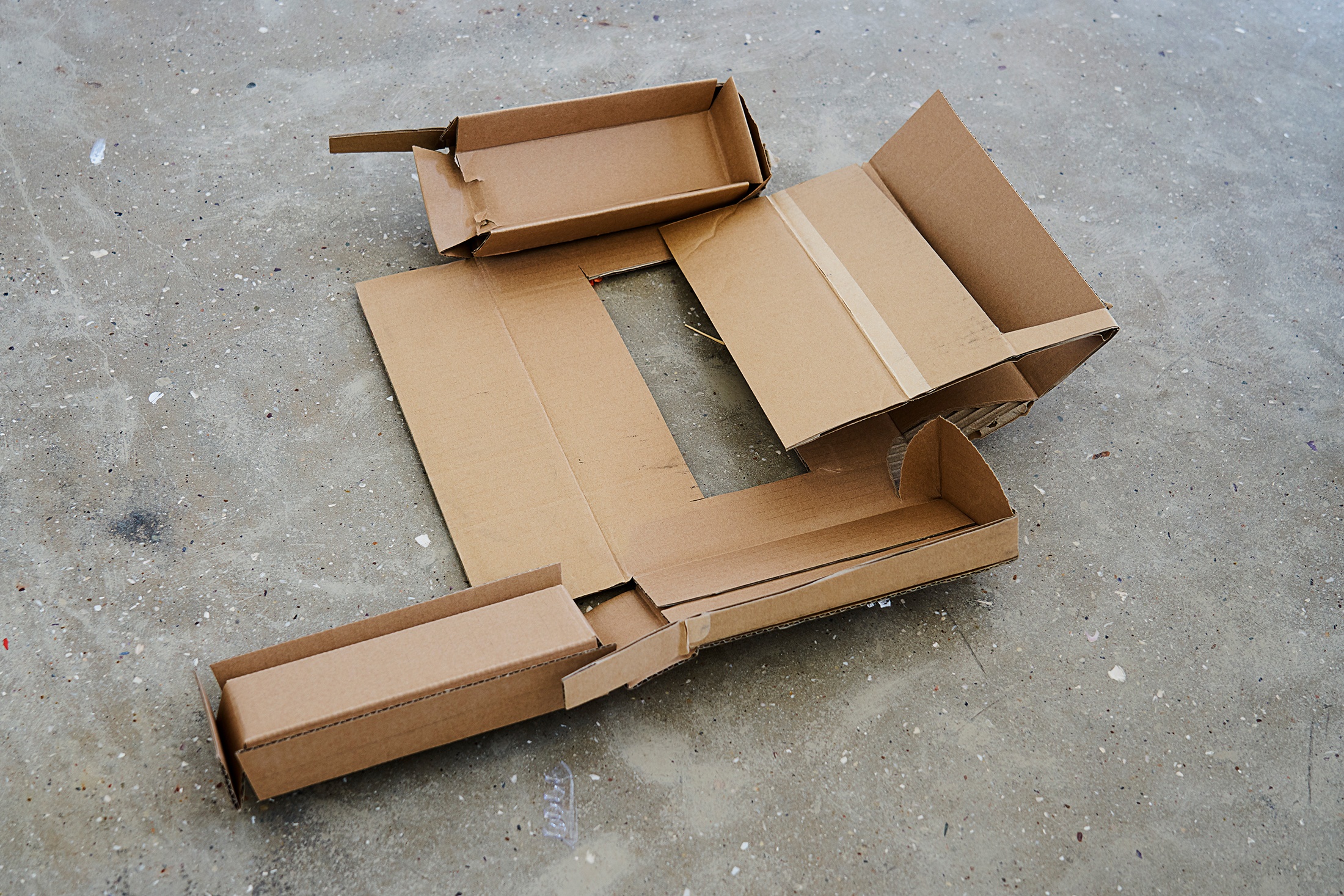 Ephemera from the ‘African Centre for Cities: City Research Studio’ exchange on A4’s top floor. A a top-down photograph shows a cardboard construction sitting on a concrete floor.
