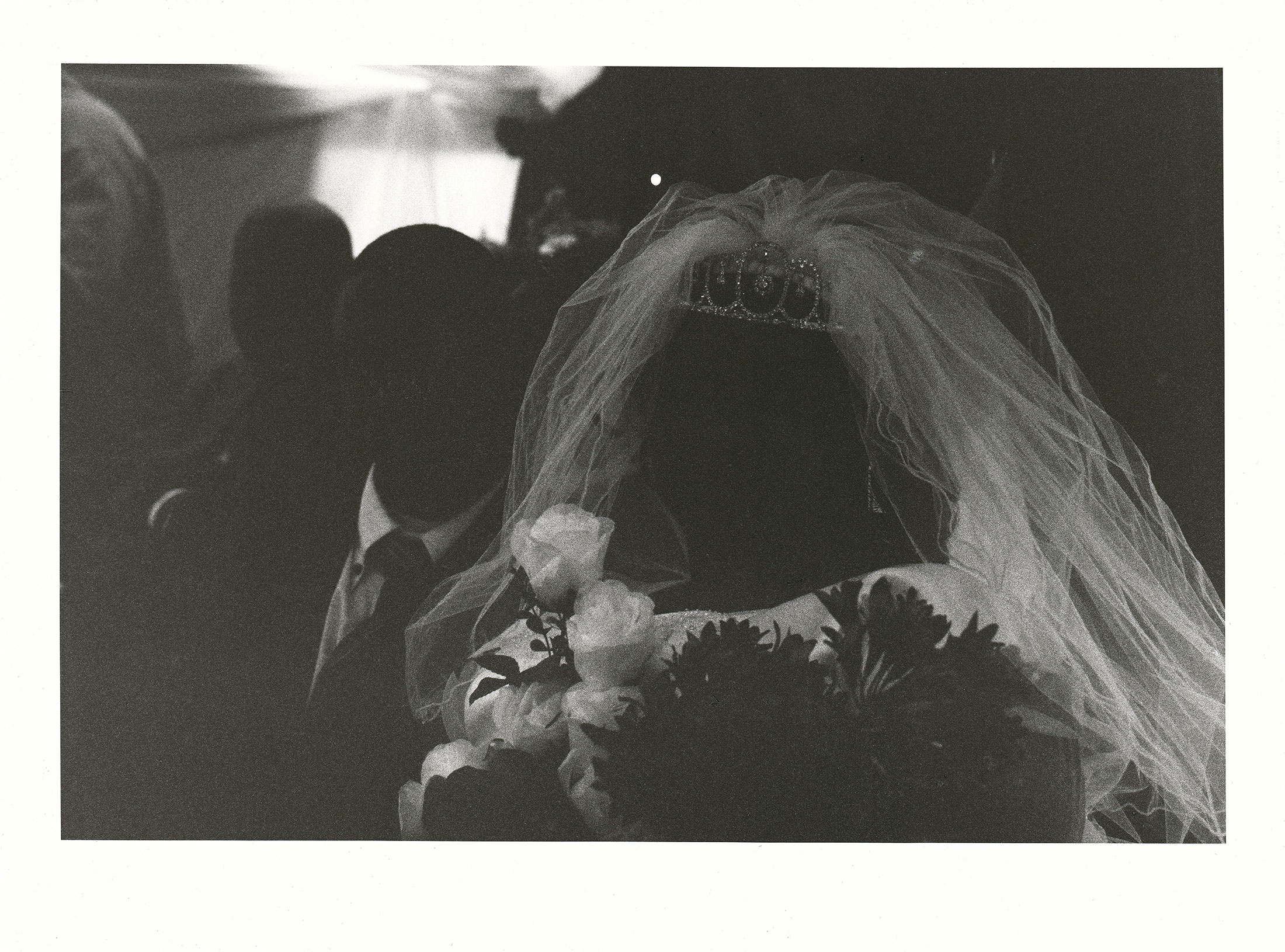 Sabelo Mlangeni’s ‘Absence of Identities’, a black and white photograph that depicts the shadowed faces of a bride and groom.
