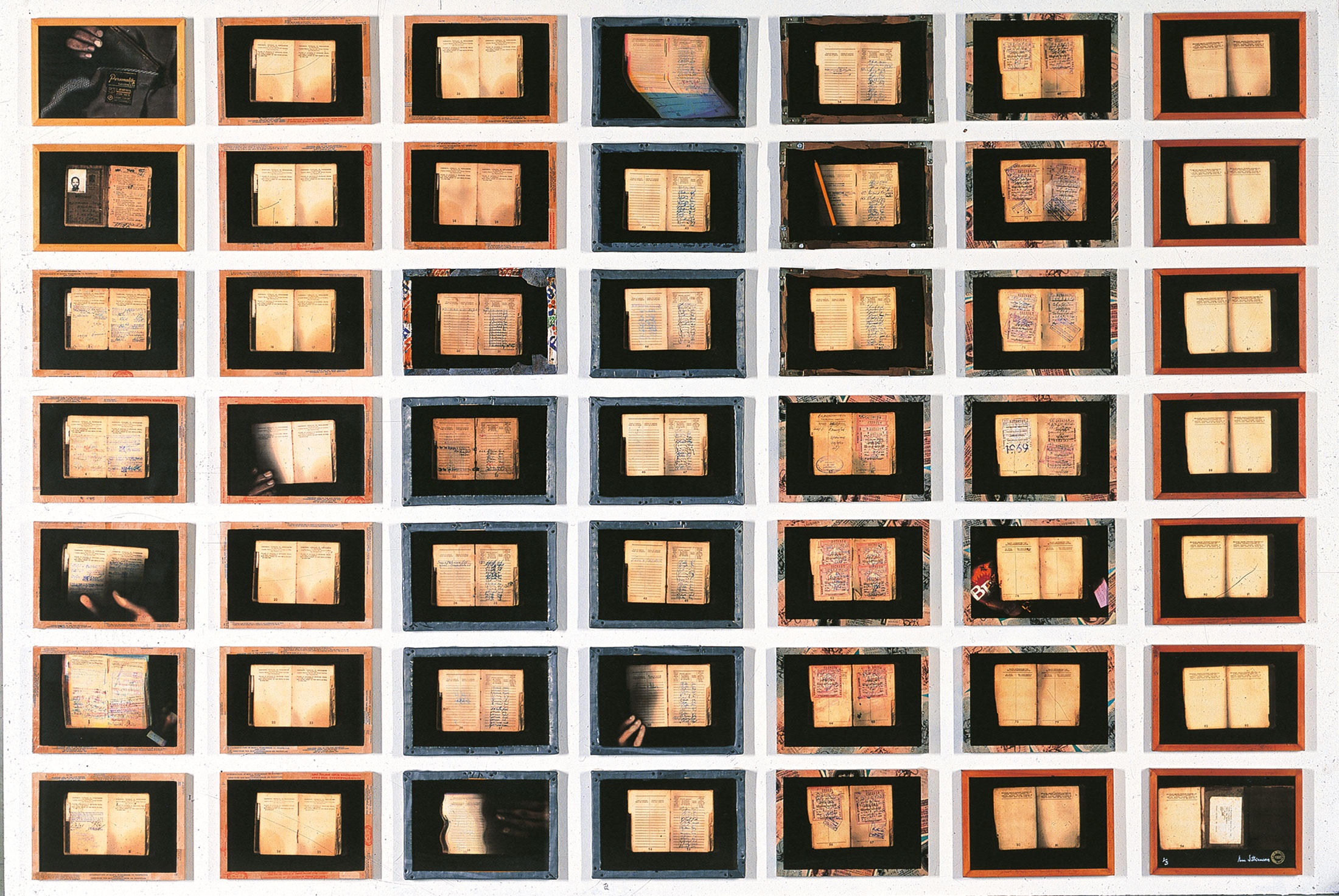 Sue Williamson’s framed grid of laser prints ‘For Thirty Years Next to His Heart’ depicts the inside pocket of a blazer and the pages of passbook.
