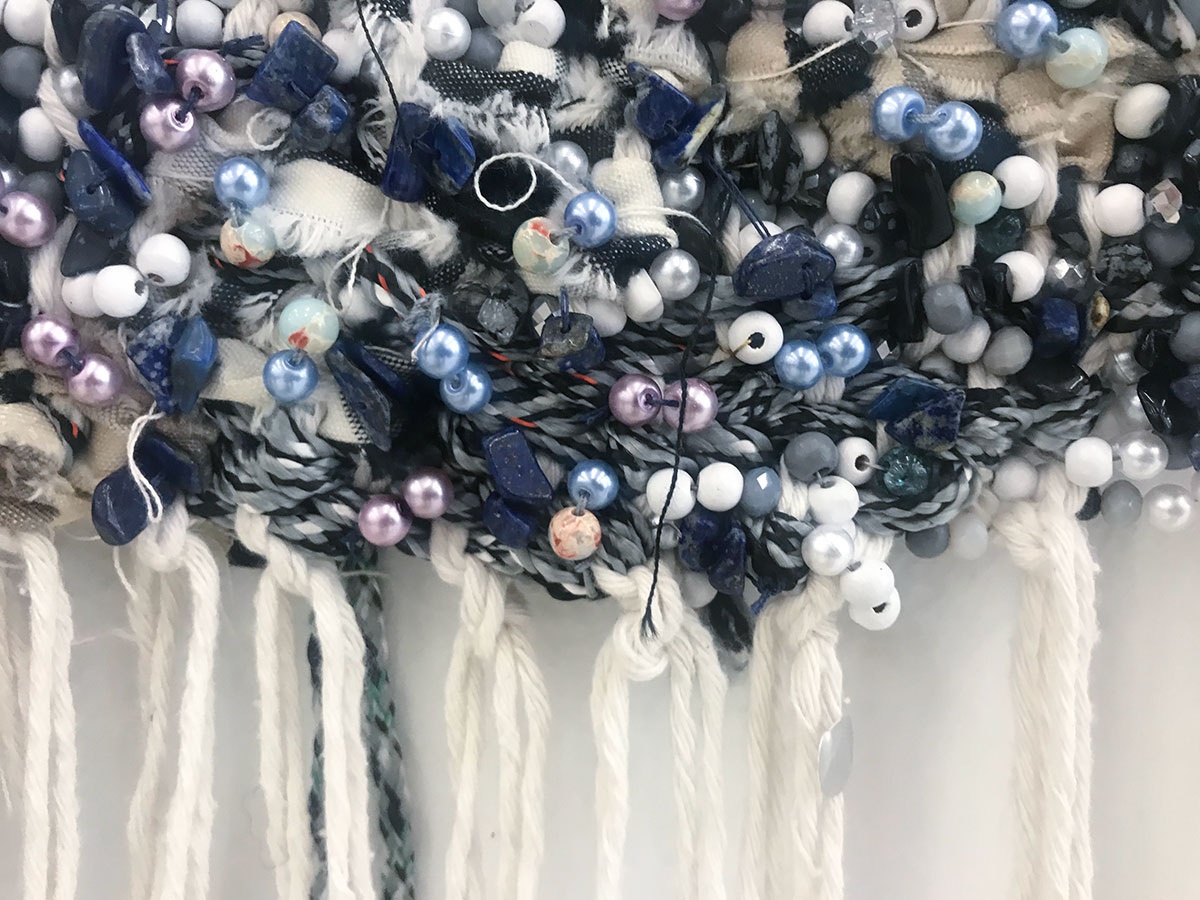 Event photograph from ‘Knots’, a conversation between Igshaan Adams and Josh Ginsburg, marking the close of ‘Open Production’, Adams’ hybrid studio/exhibition in A4’s Gallery. A closeup view shows a detail of one of Adams’ textile works.
