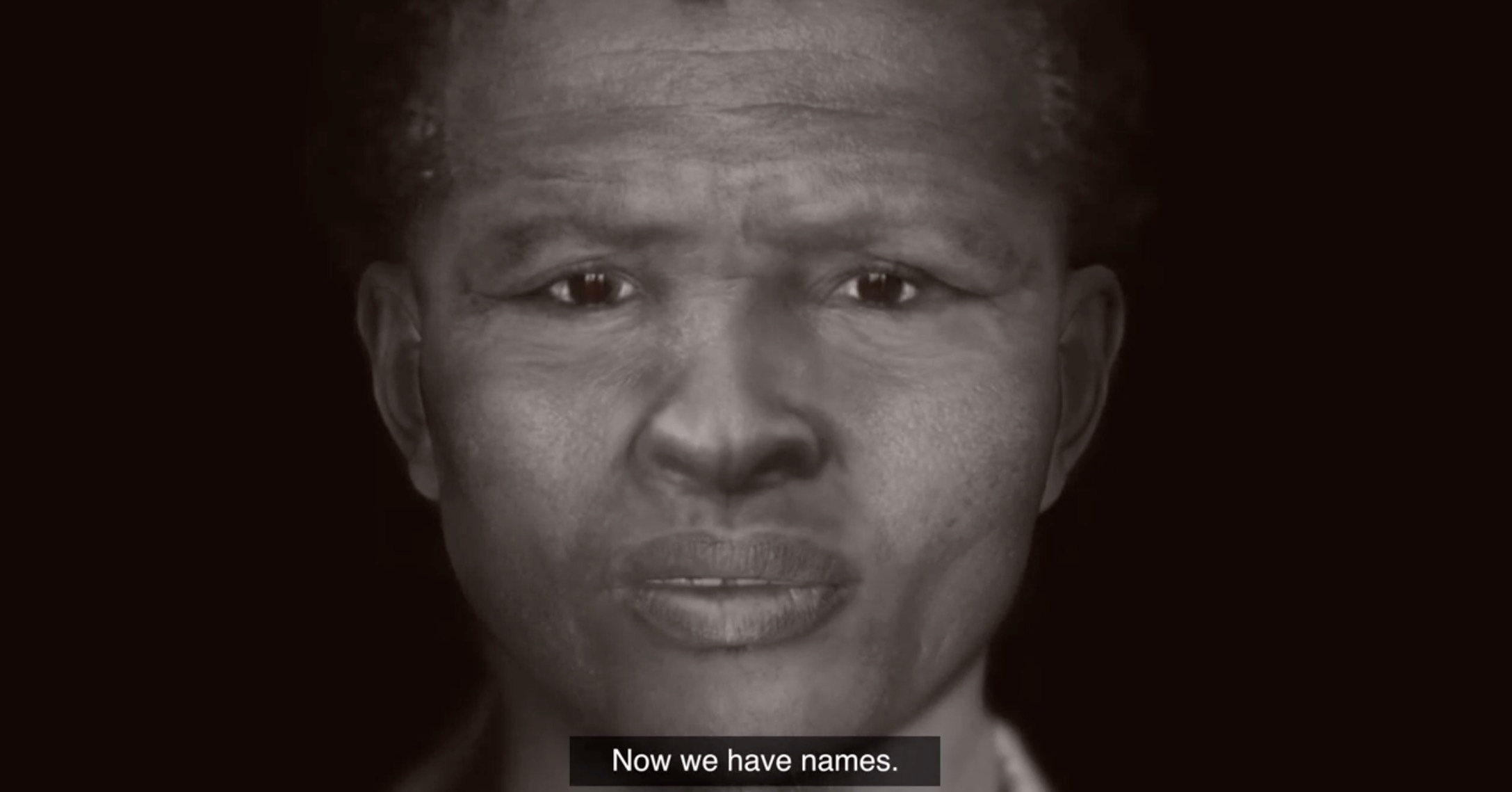 Process image from Kathryn Smith’s 2019 residency on A4’s top floor. A video still from the University of Cape Town’s video feature on the UCT Sutherland Reburial project that shows a cranio-facial reconstruction by Kathryn Smith and subtitles that read ‘Now we have names.’
