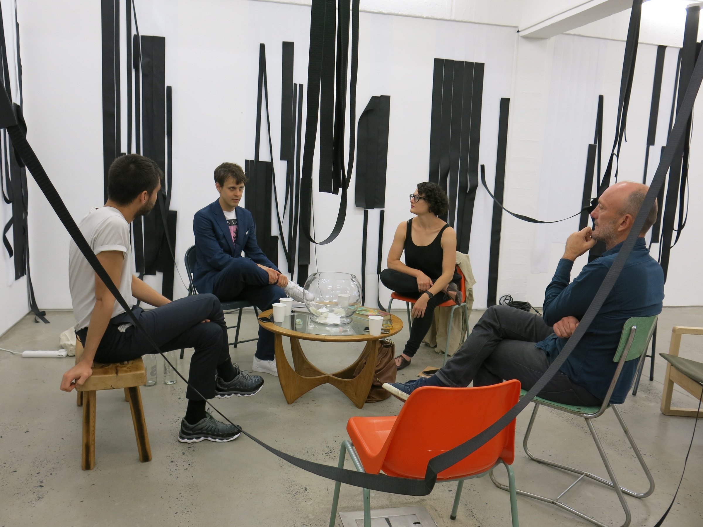 Process photograph from the ‘Dream Works’ event on A4’s ground floor. Sitting among Unathi Mkonto’s interactive velcro installation ‘AVOID’, participants Simon Asencio, Adriano Wilfert Jansen, Anthea Buys and Sean O’Toole are seated around a coffee table.
