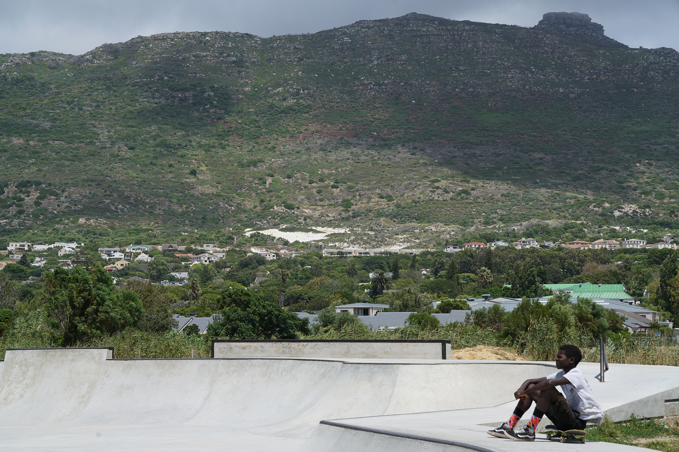 Kevin Beasley's photographic print 'Zola' depicts a concrete skatepark at the front, and a mountain in the background.
