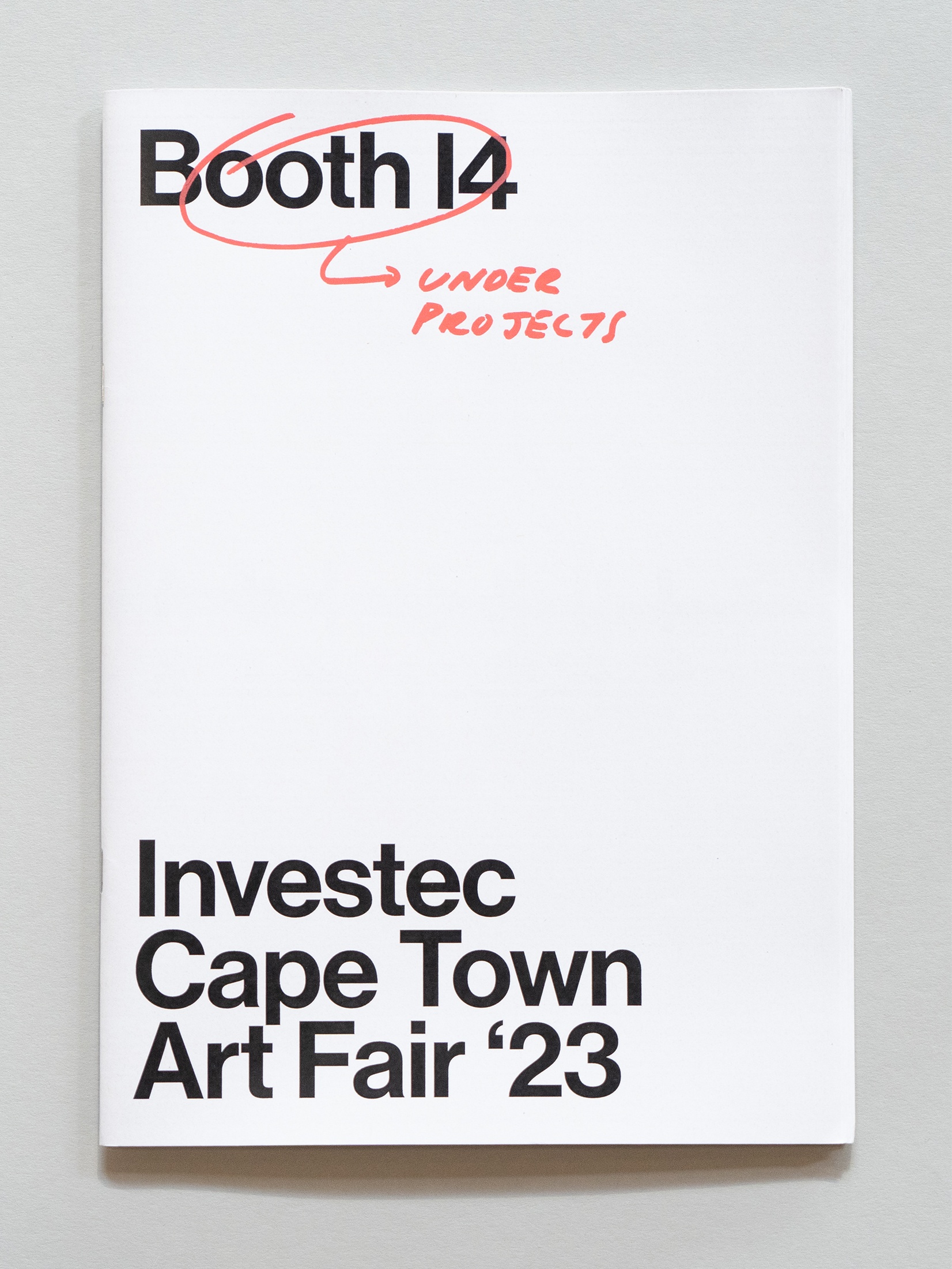 Photograph of the wayfinder publication for Under Projects x A4, Booth 14 curated by Mitchell Gilbert Messina, Luca Evans, Brett Charles Seiler and Guy Simpson at the 2023 Investec Cape Town Art Fair.
