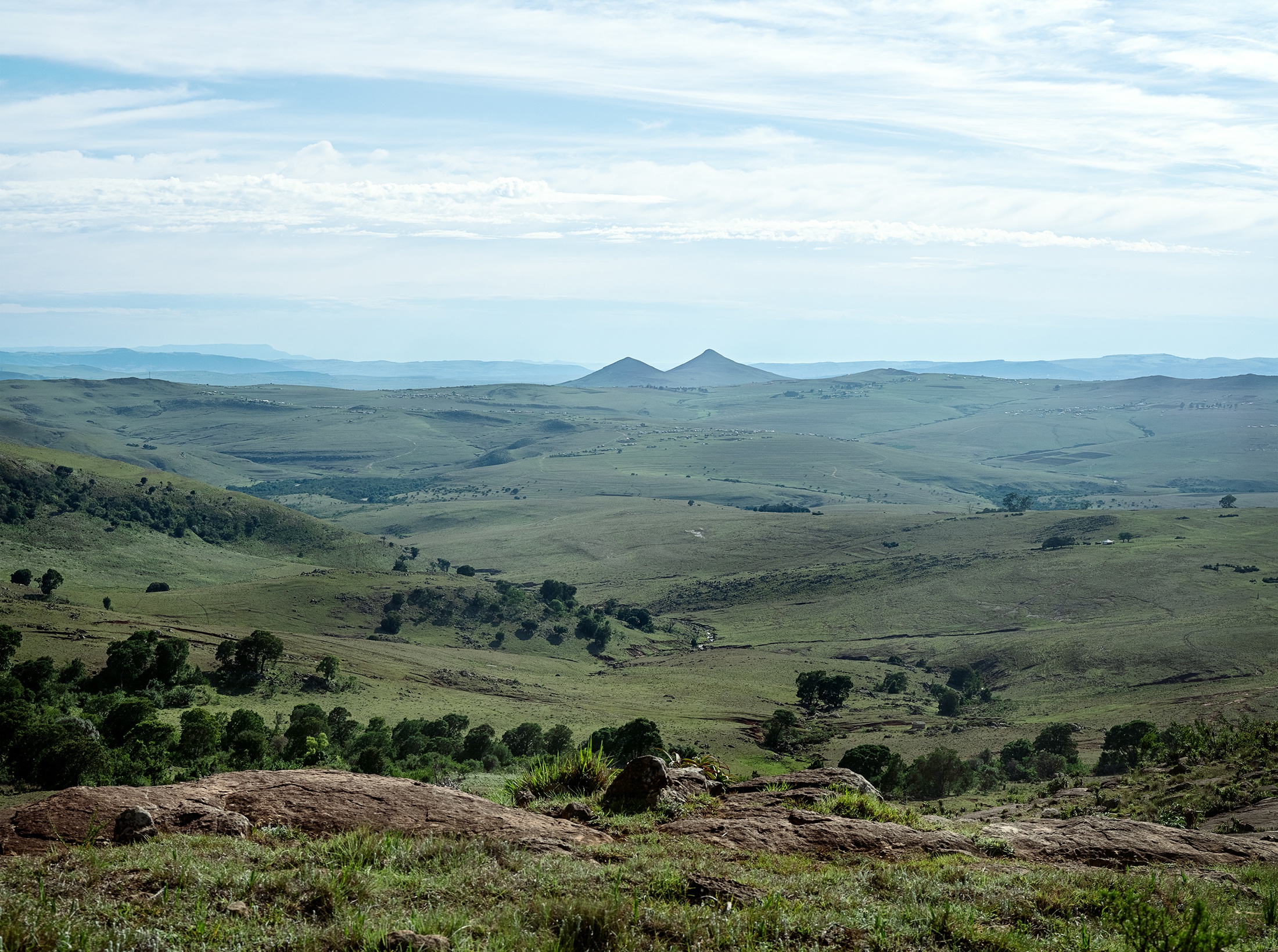 Lindokuhle Sobekwa's photograph 'Amabele weNtombi' shows a landscape of grassy hills.
